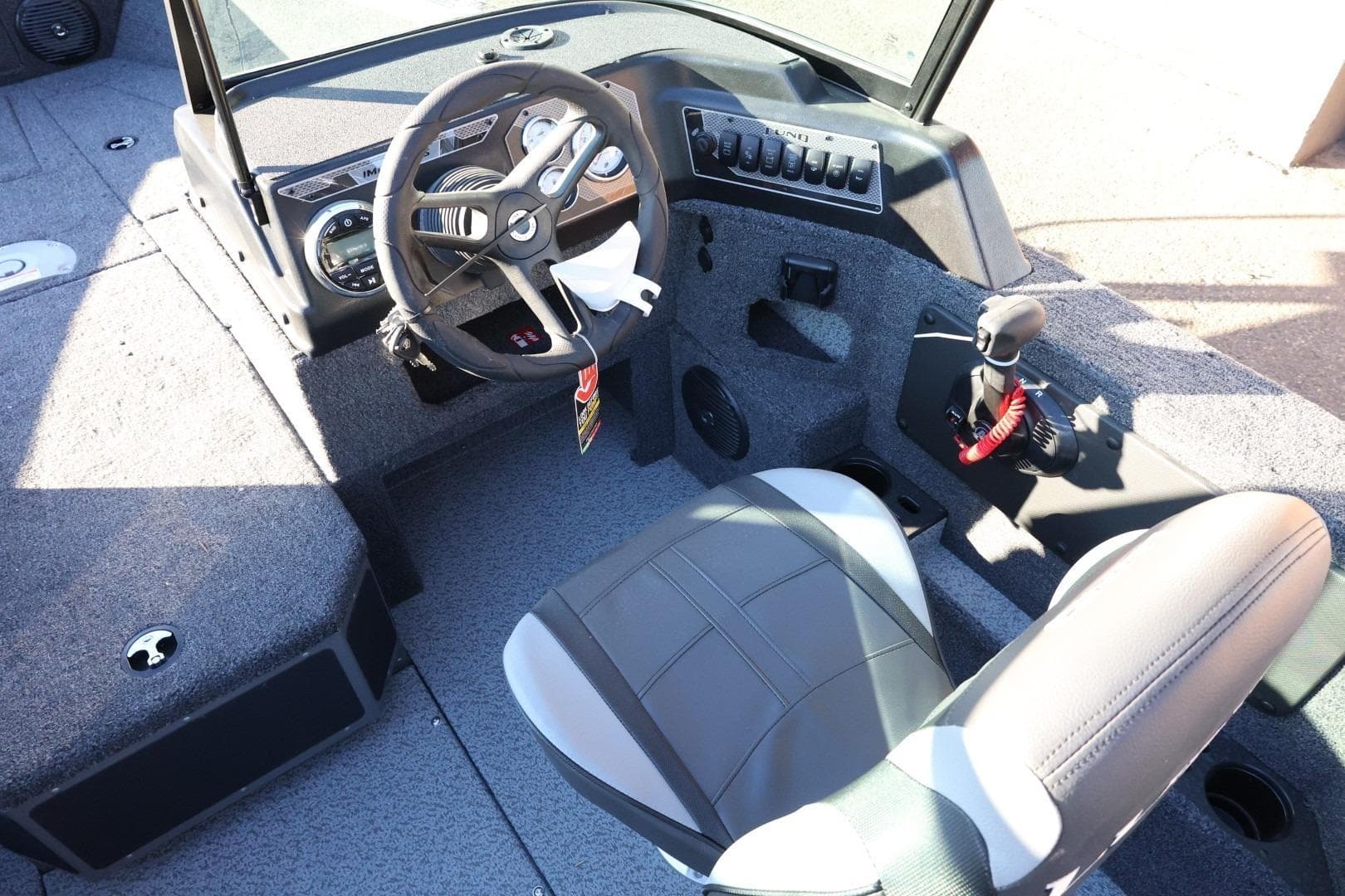 2026 Lund 1775 Impact XS Sport boat interior with steering wheel and controls.