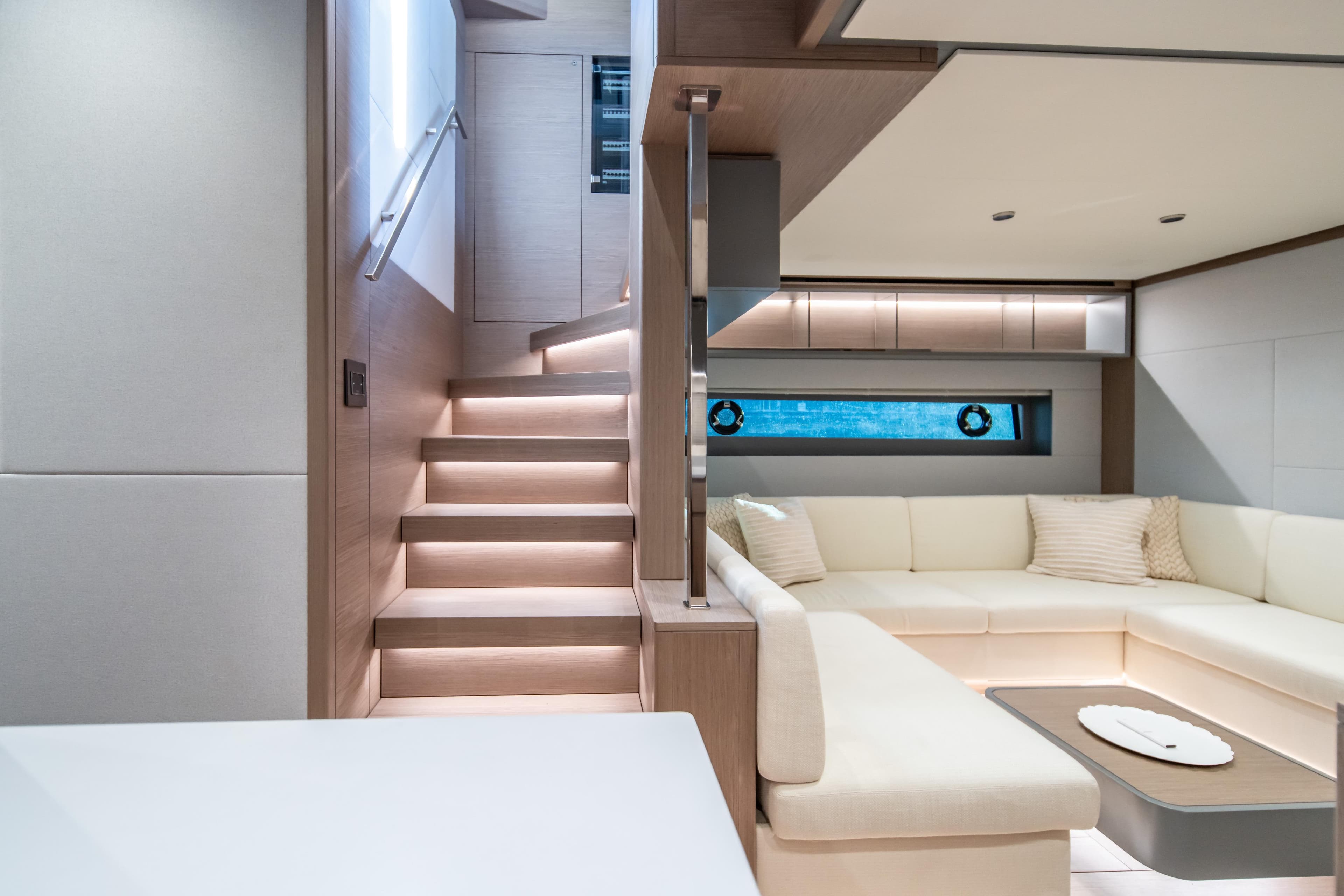 Luxurious interior of 2027 Pardo Yachts GT75 with modern staircase and elegant seating area.