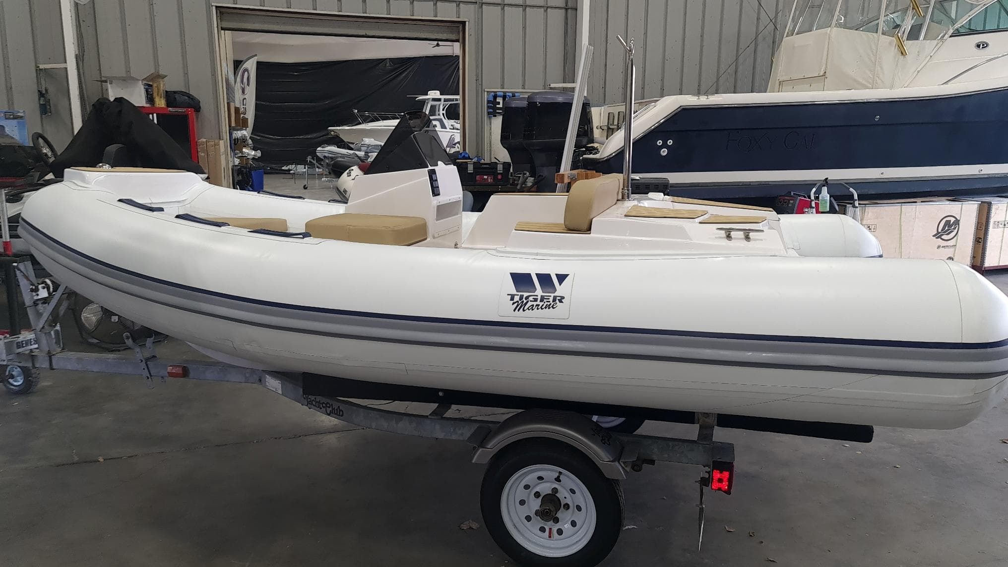 2023 Tiger Marine 370 PROTENDER inflatable boat on trailer in a storage facility.