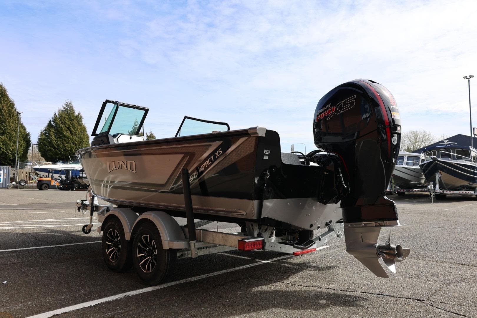 2026 Lund 1875 Impact XS Sport boat on trailer, featuring powerful outboard motor.