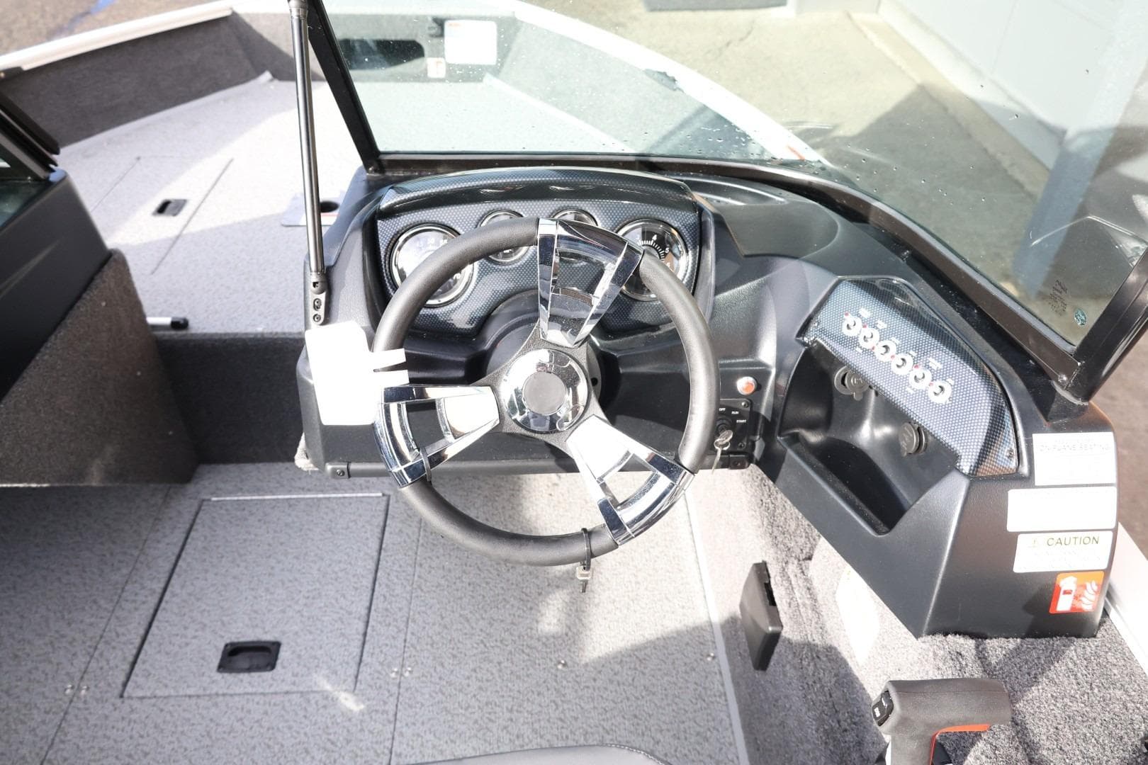 2026 Lowe Fishing Machine 1675 WT boat dashboard with steering wheel and controls.