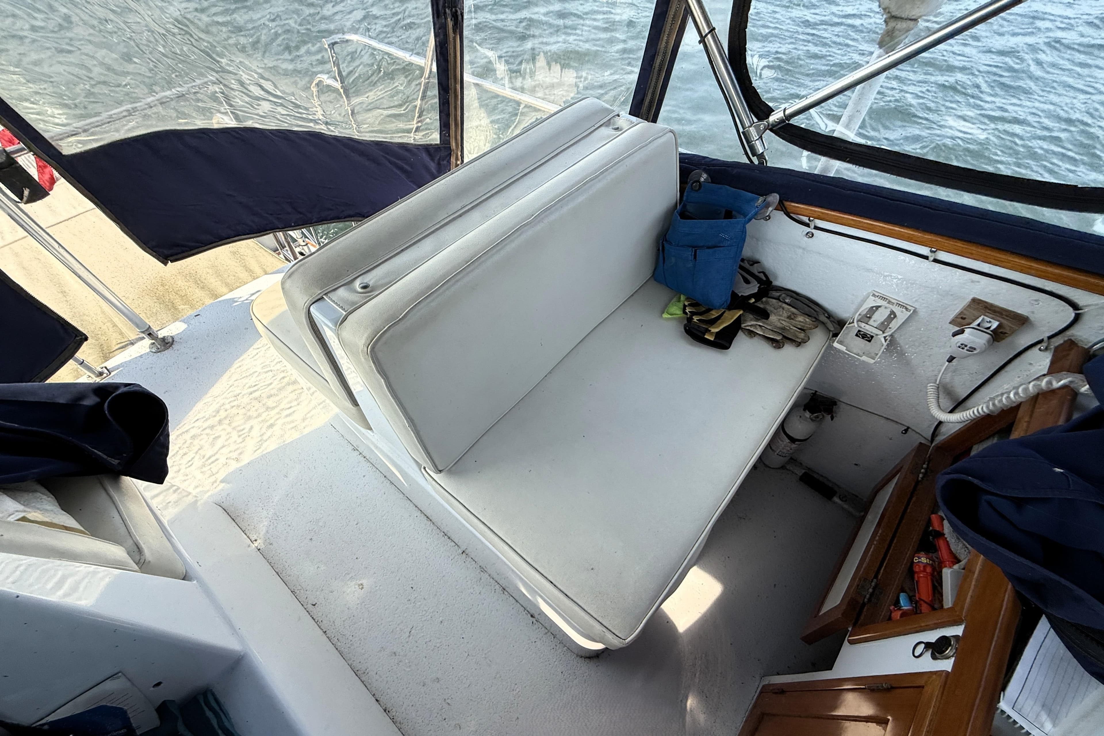 Interior of 1983 Wilbur 34 Fly Bridge Cruiser with white seating and nautical equipment.