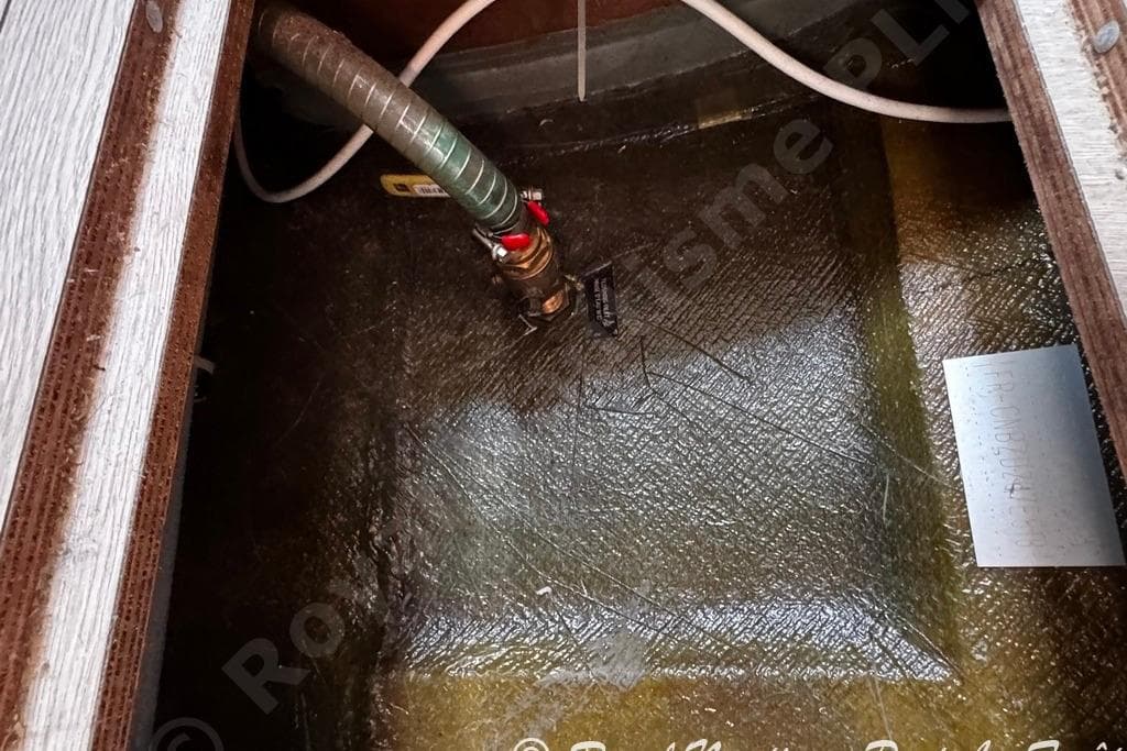 Bilge area of a 2018 Lagoon 42 catamaran with visible hose and fittings.