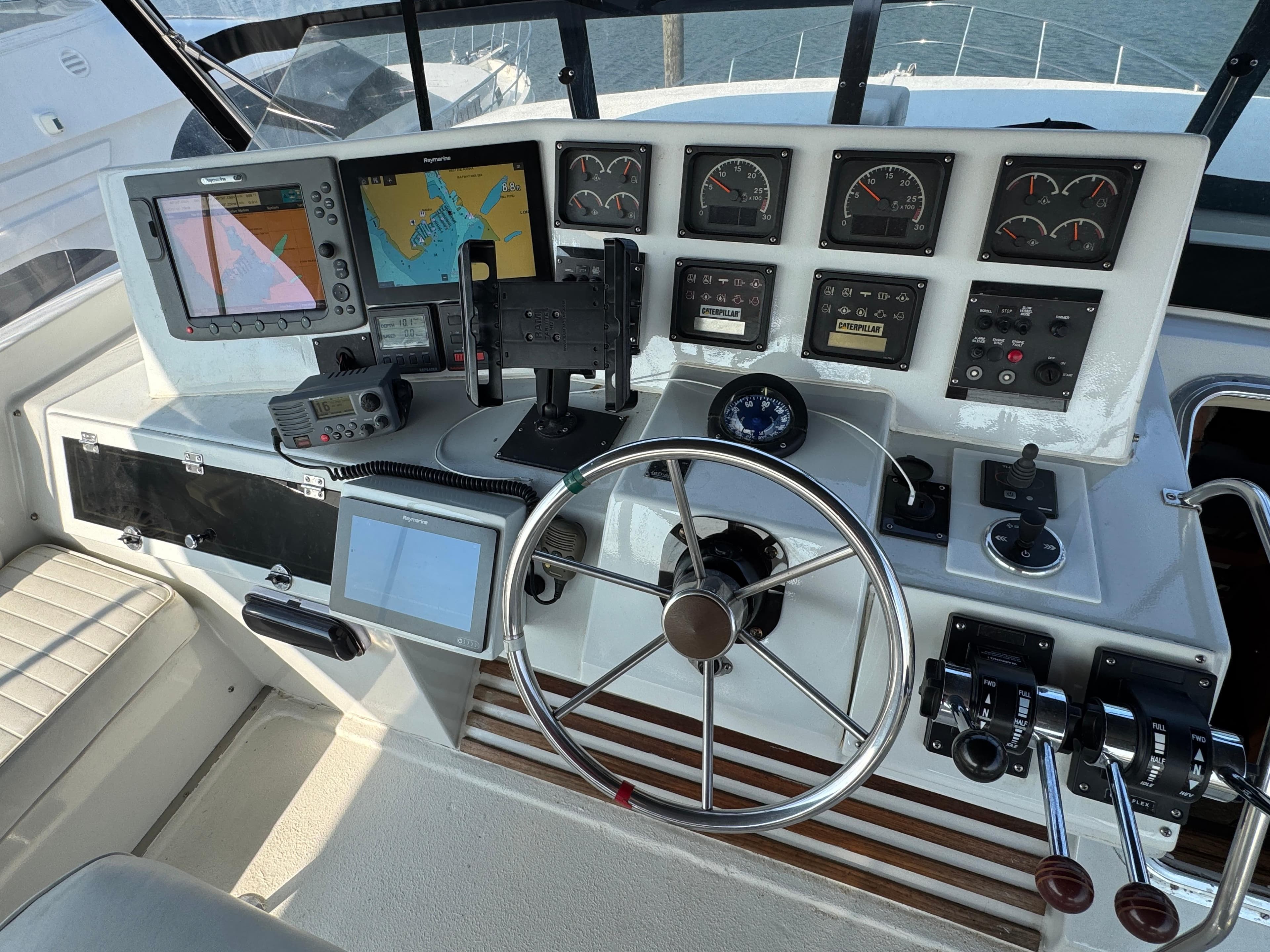 Cockpit of 1989 Birchwood 62 Motor Yacht with navigation instruments and steering wheel.