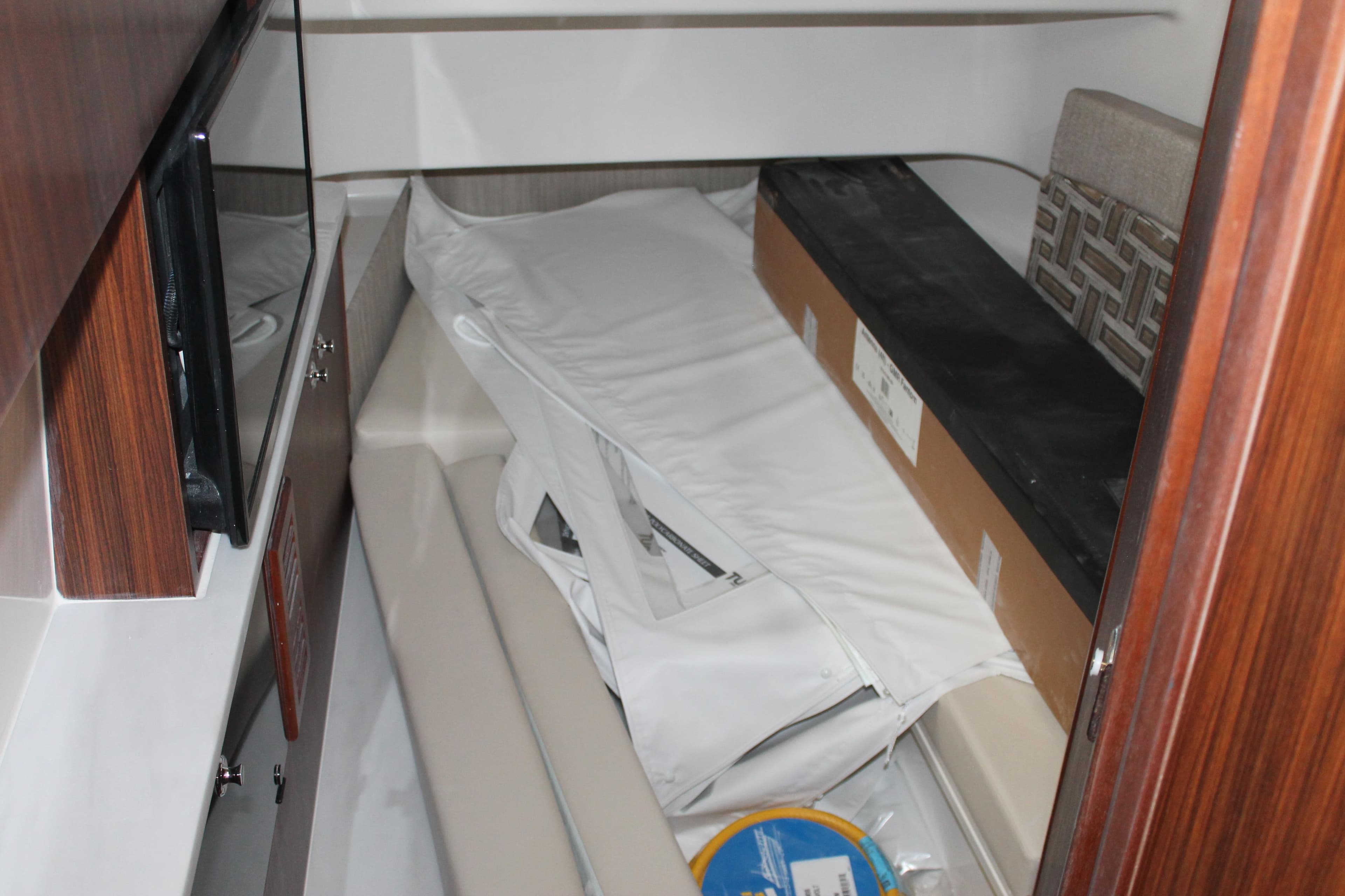 Interior cabin of 2025 Pursuit S 358 Sport boat with storage items.