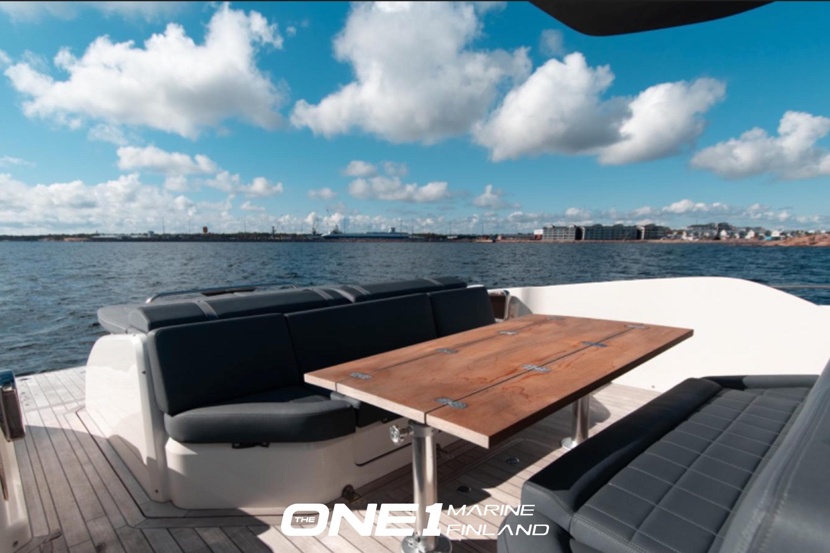 Luxury SACS Rebel 47 yacht deck with seating and table, 2017 model, ocean view.