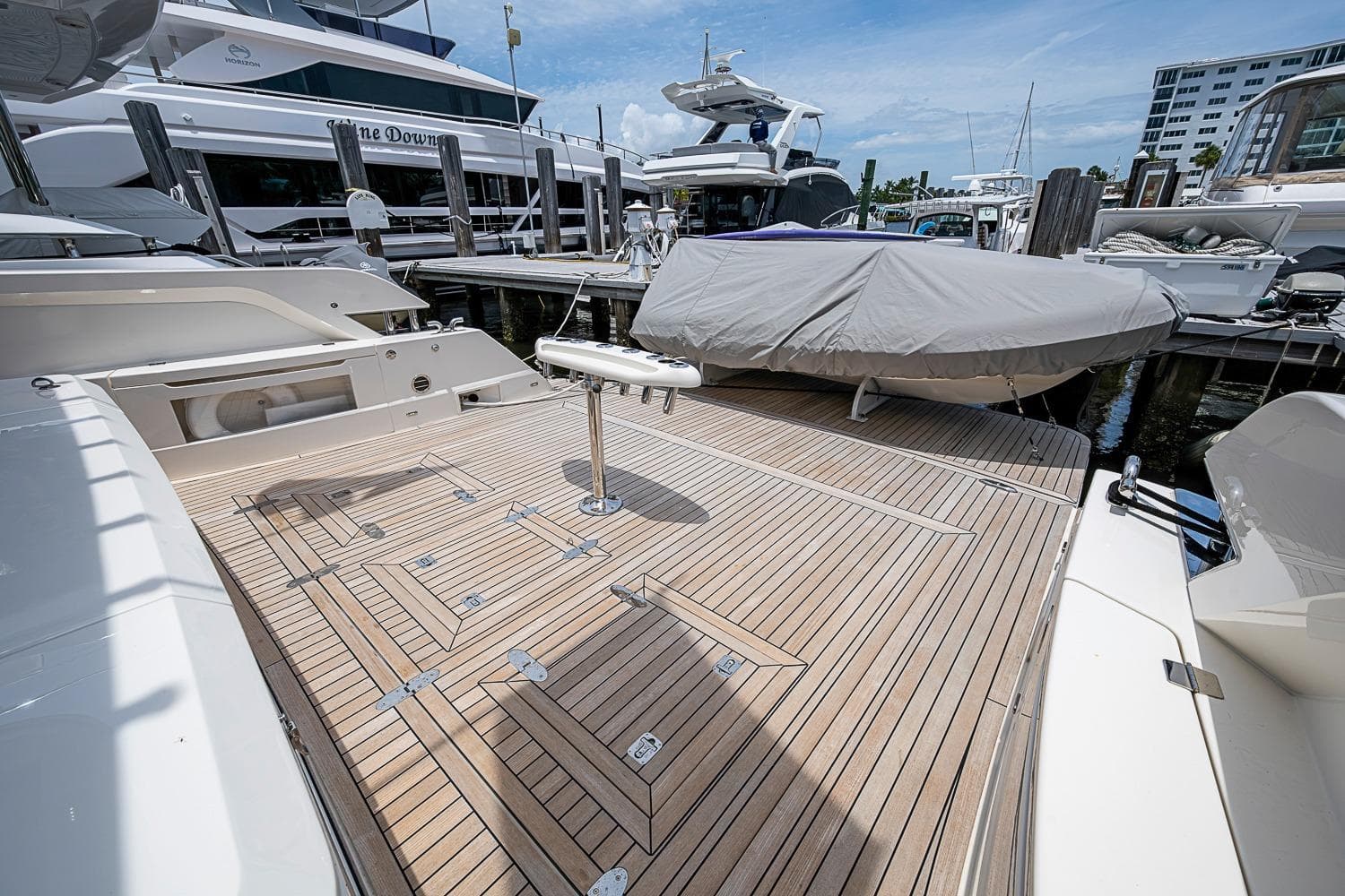 2025 Maritimo M75 yacht deck with covered boat, docked at marina.