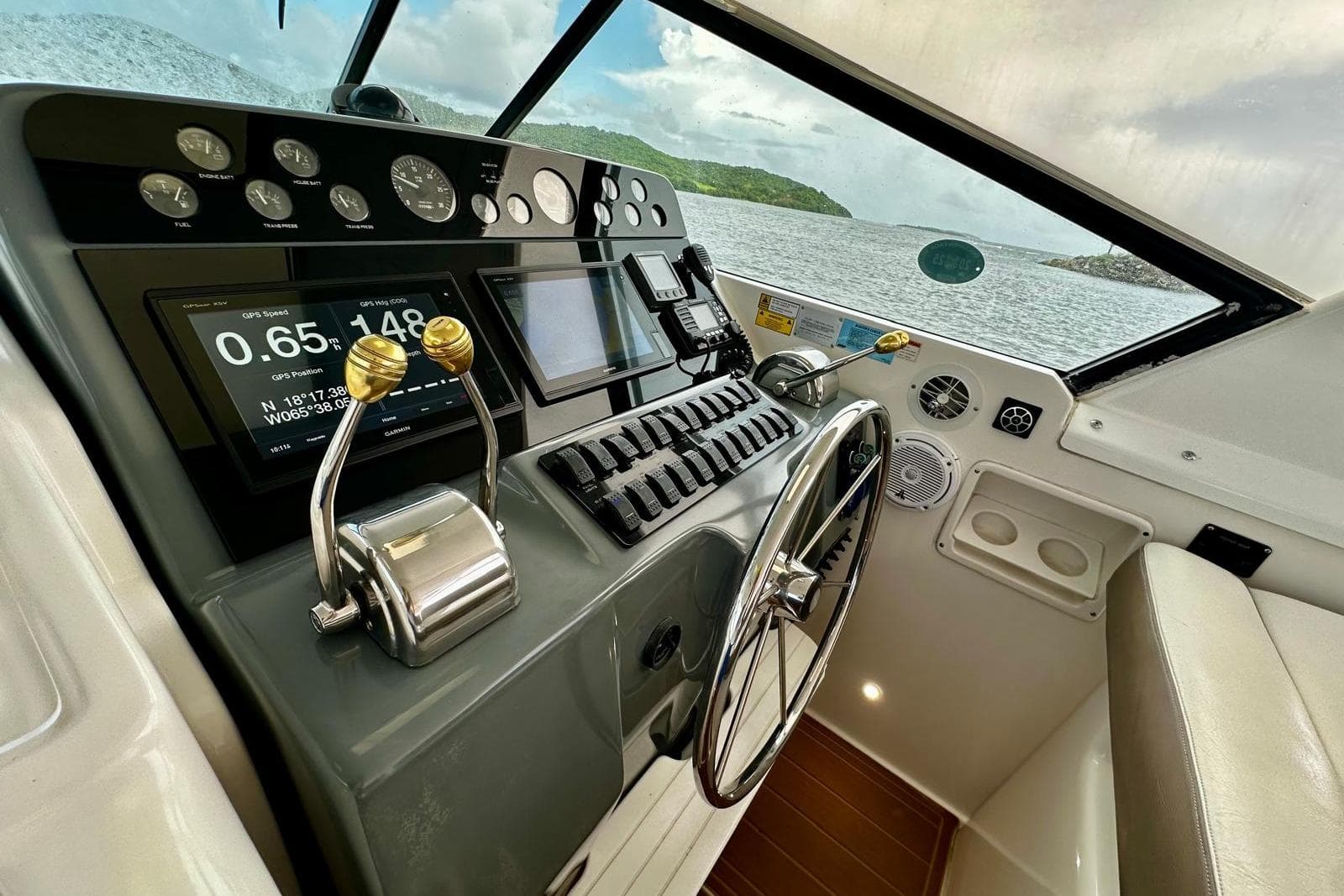 Cockpit of 2003 Tiara Yachts 4000 Express with navigation controls and scenic view.