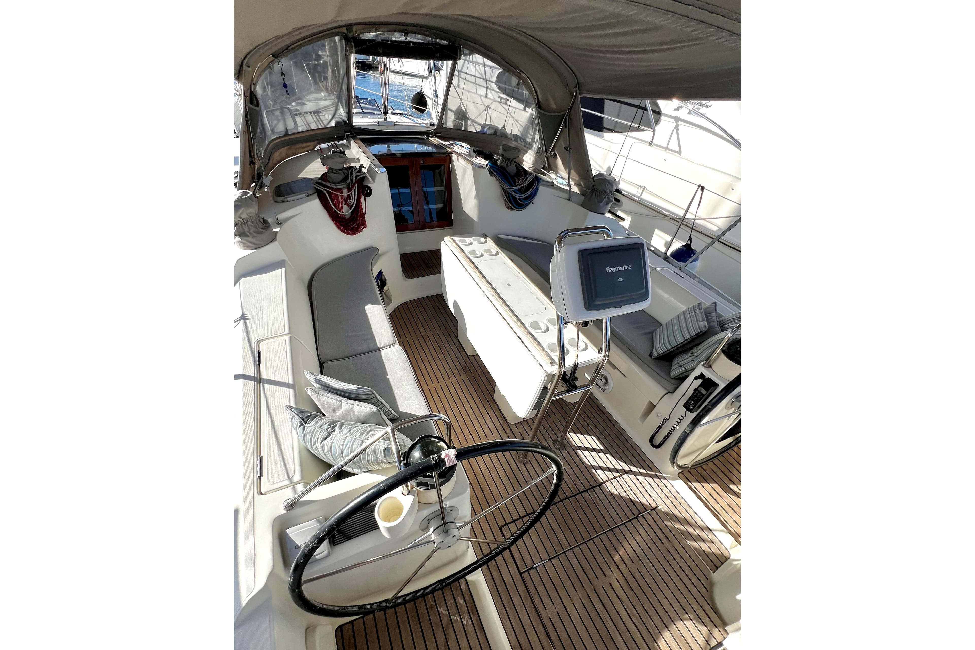 Interior view of 1995 Jeanneau Sun Odyssey 45.1 sailboat cockpit with seating and navigation equipment.