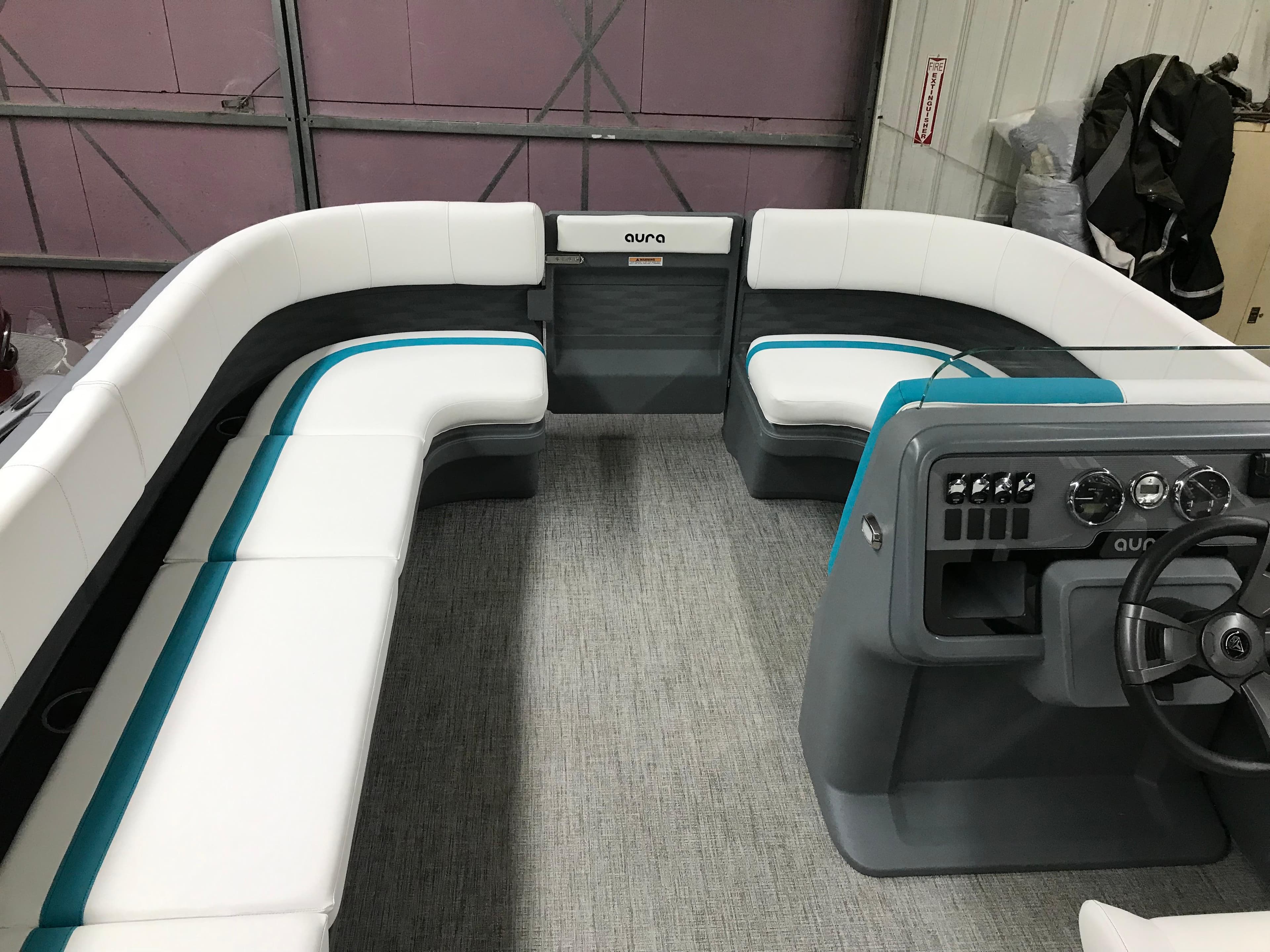 2025 Avalon AURA boat interior with white seating and modern dashboard.