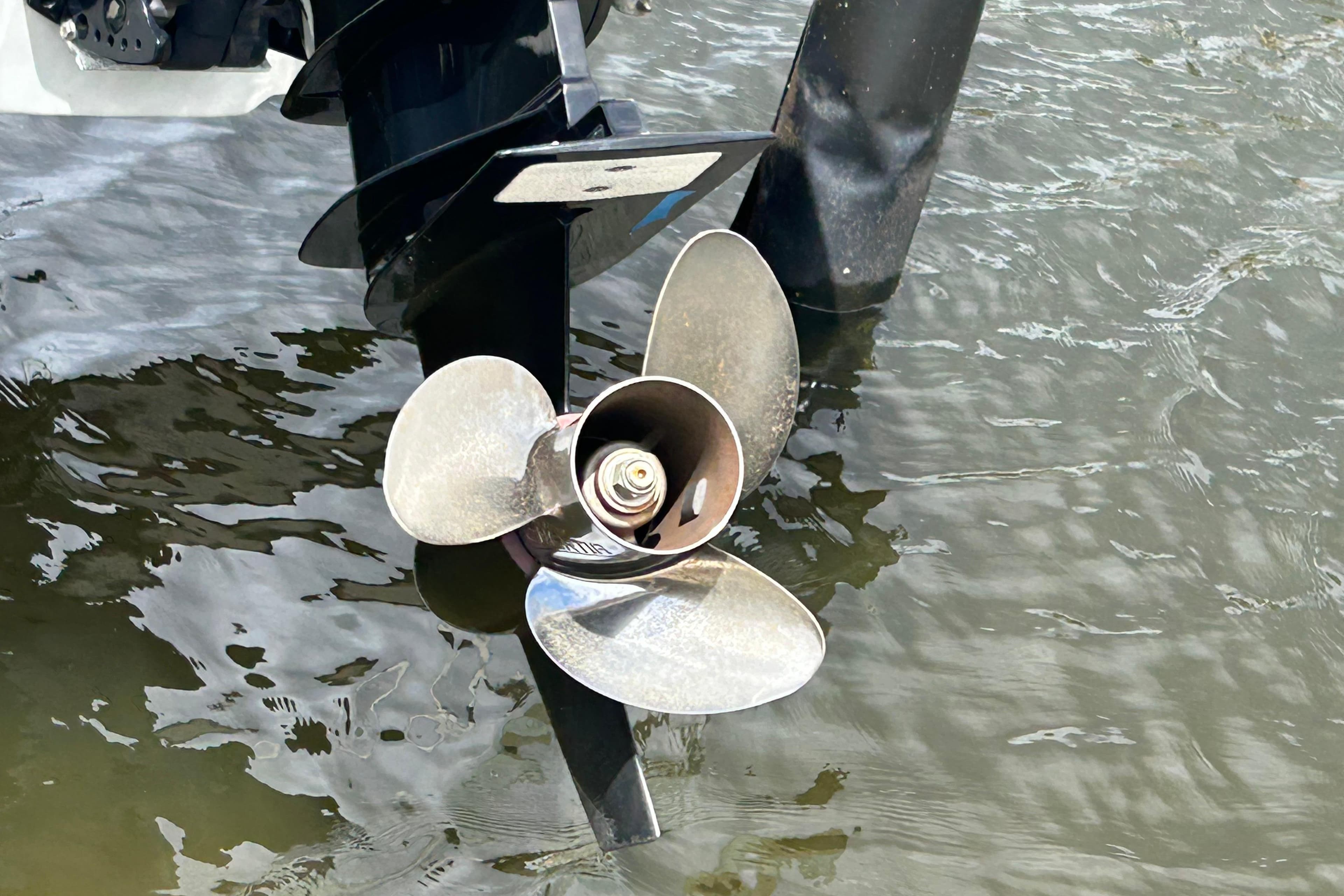 Propeller of 2022 Crownline 270 XSS boat in water, close-up view.