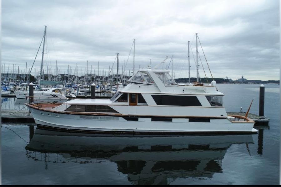 1974 Pacemaker Cockpit Motoryacht docked in a marina under cloudy skies.
