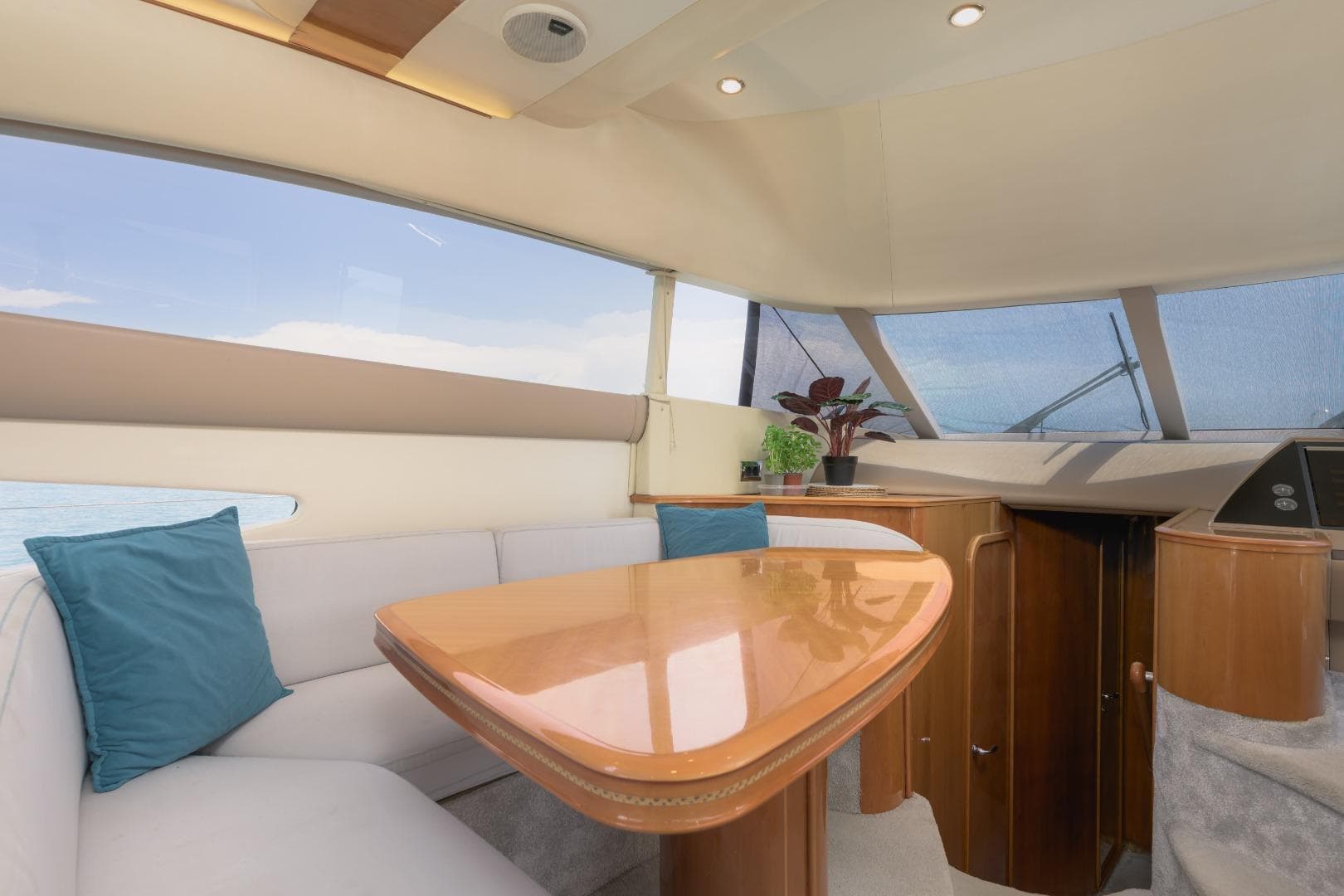 Luxurious interior of 2001 Princess 61 yacht with elegant seating and wooden table.