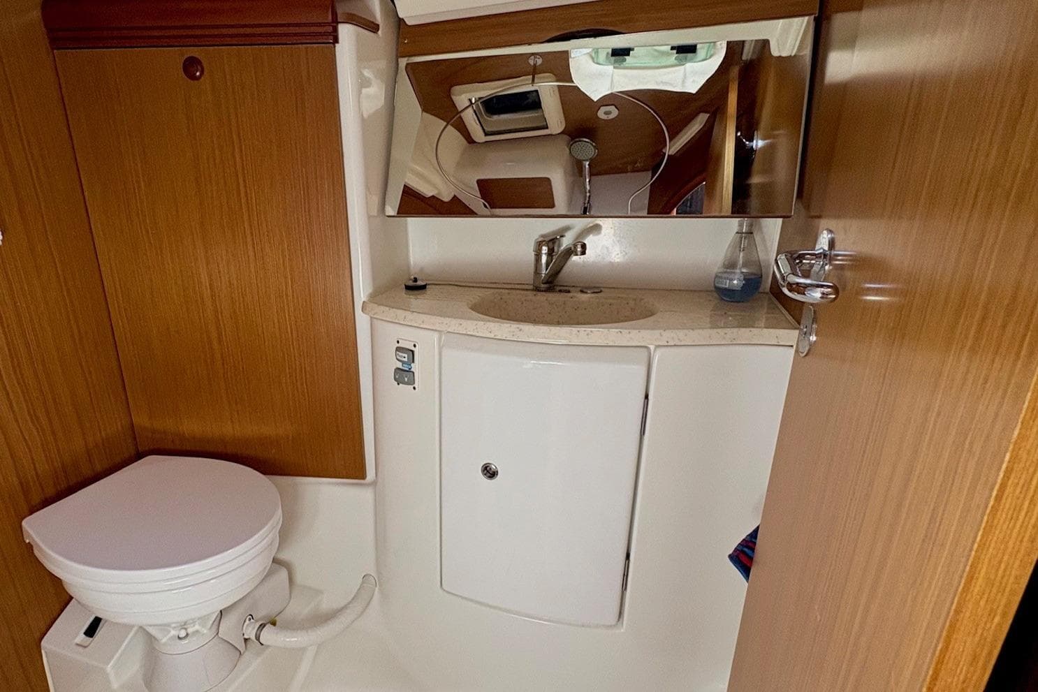 2007 Jeanneau Sun Odyssey 42 DS yacht bathroom with wooden cabinetry and modern fixtures.