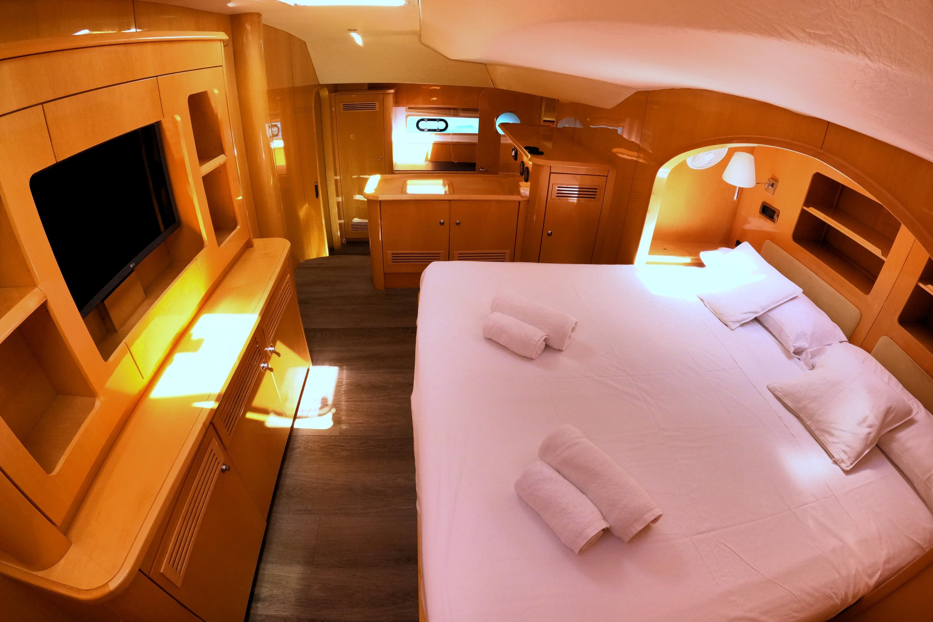 Luxurious cabin interior of 2007 Privilege 615 yacht with cozy bed and modern amenities.