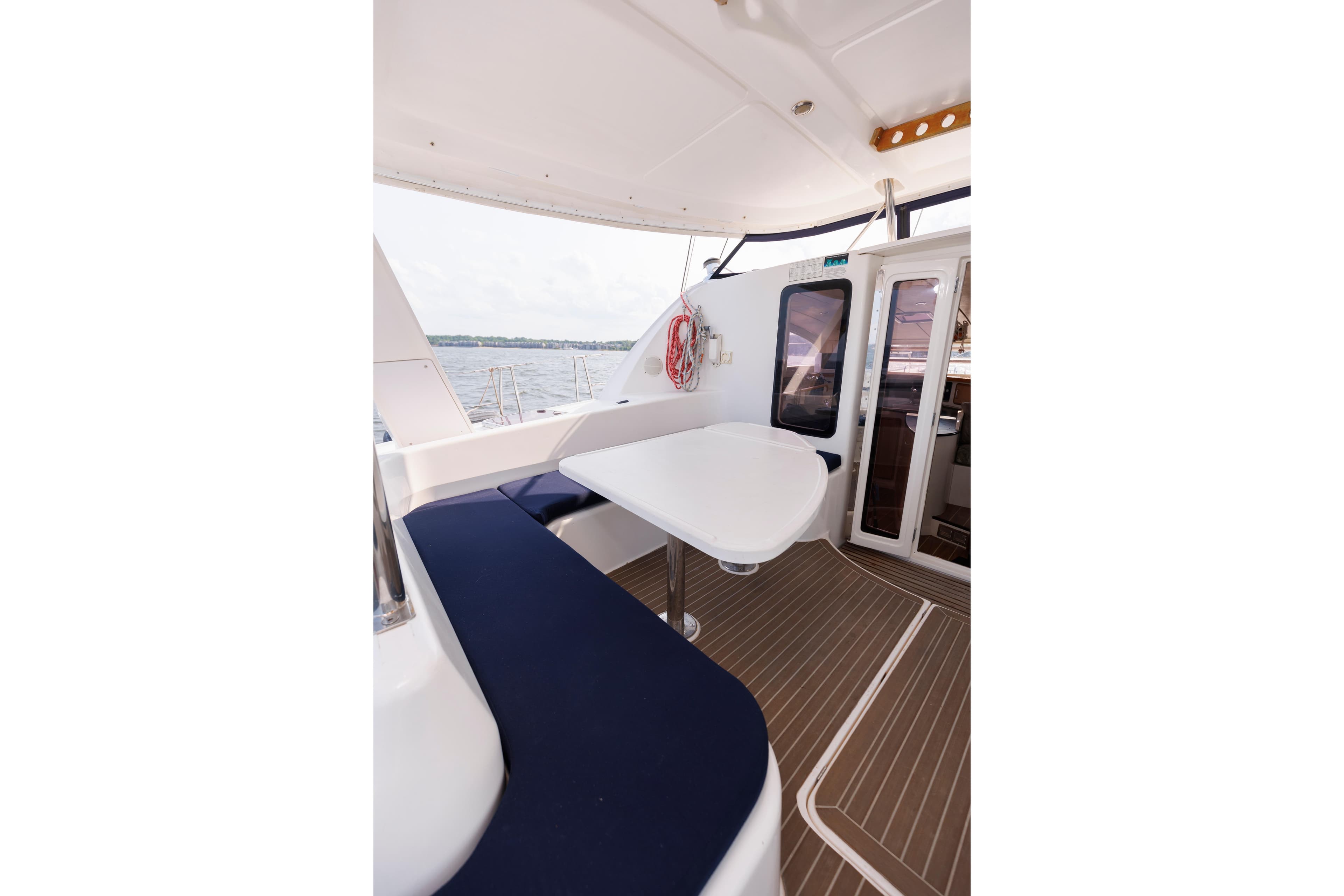 Leopard 43 catamaran deck with seating area, 2006 model, overlooking the water.