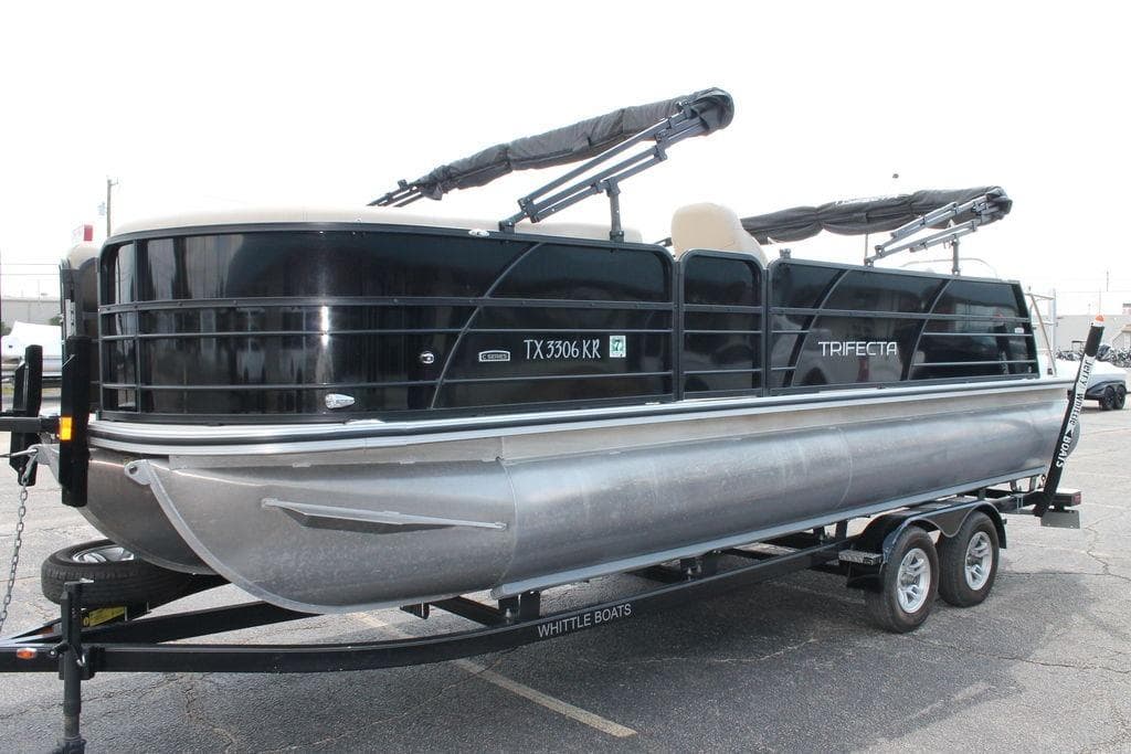 2023 Trifecta 24UL-CS pontoon boat on trailer, black and silver design.