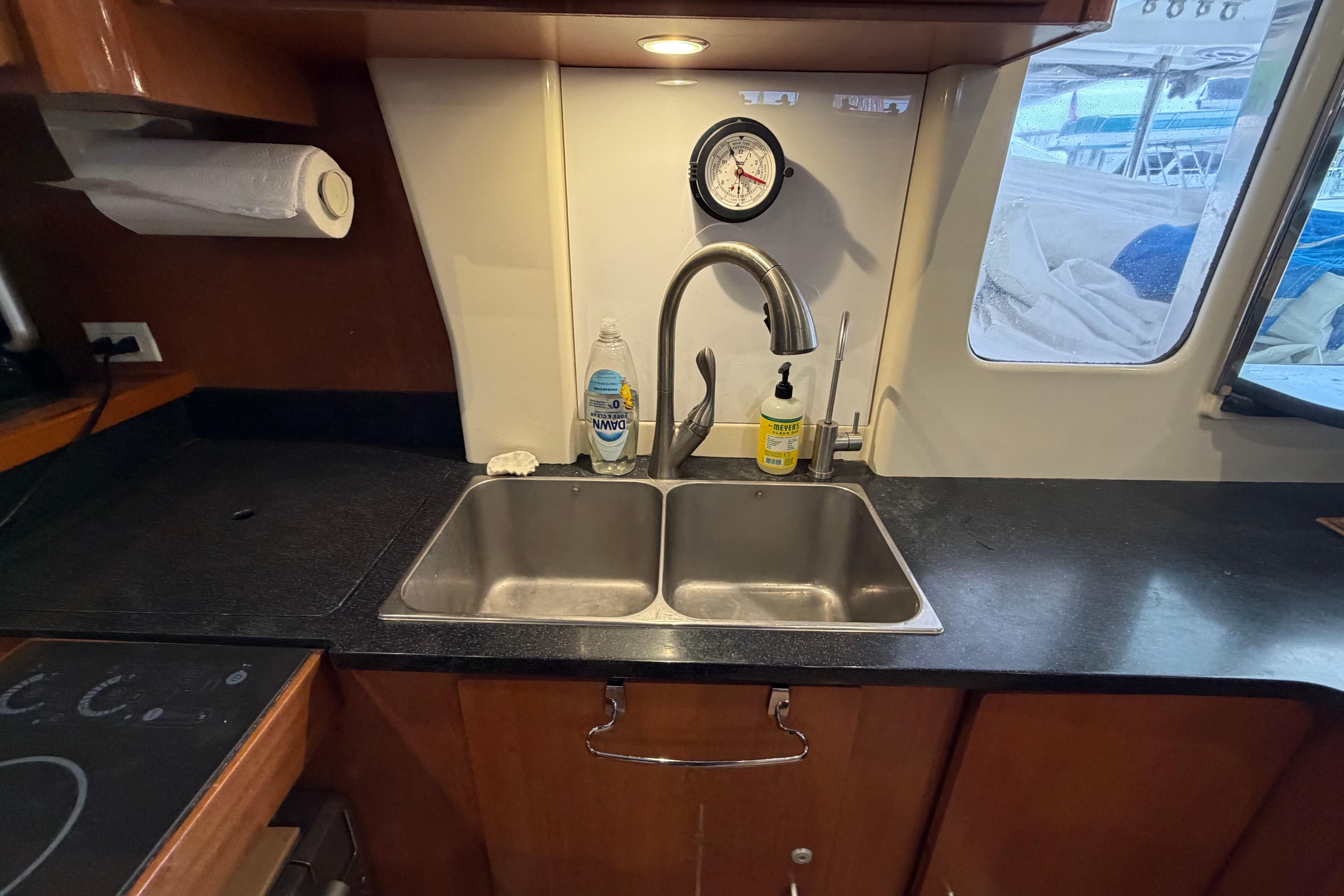 Kitchen sink area in a 2007 Leopard 46 yacht with countertop and window view.