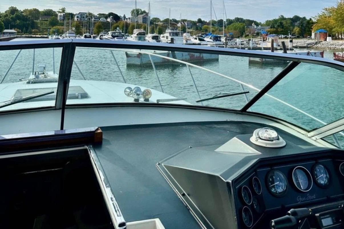 1987 Wellcraft 3400 Gran Sport boat dashboard with marina view in the background.