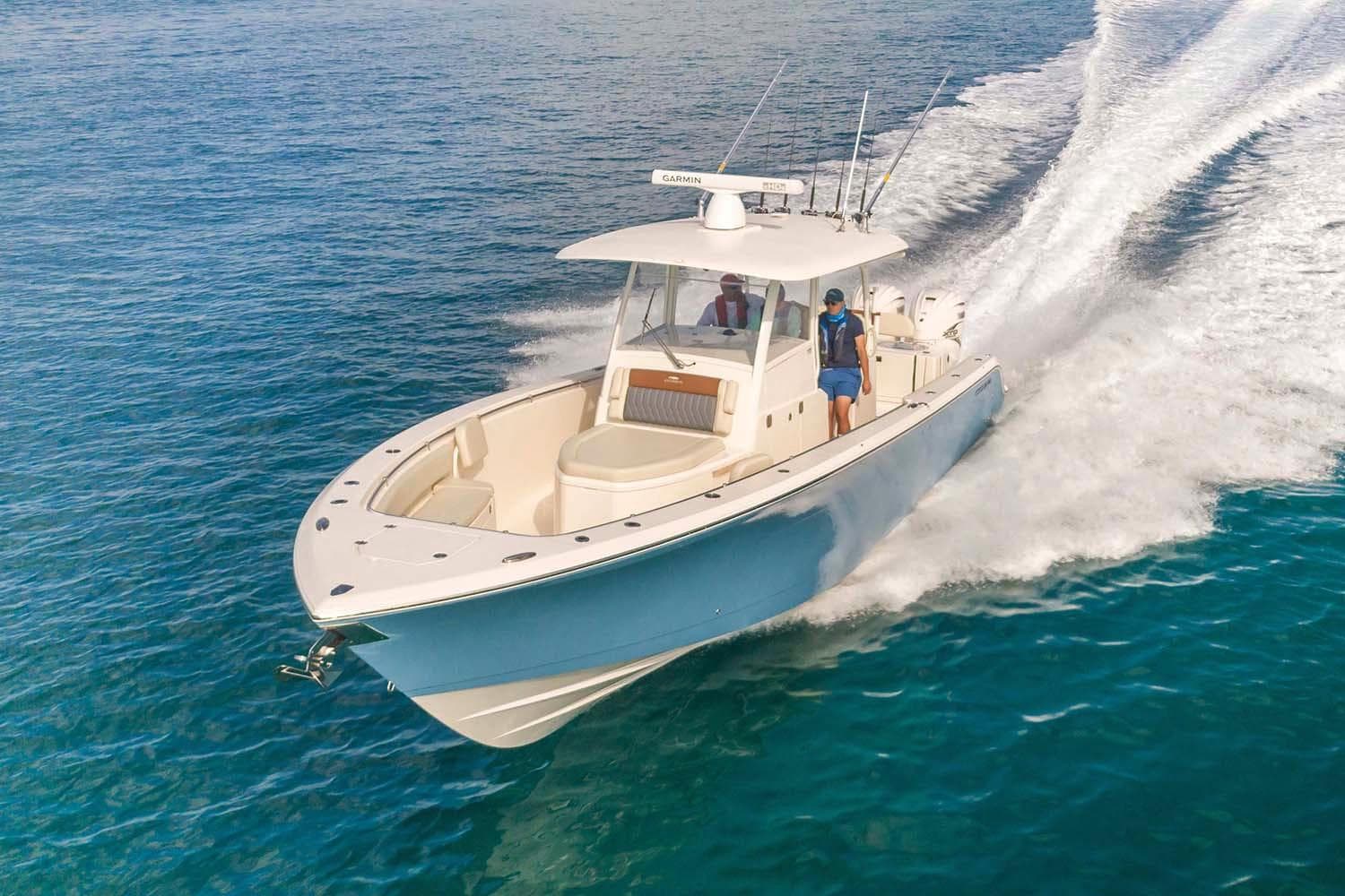 Manufacturer Provided Image: 2025 Cobia 350 Center Console boat cruising on clear blue water.