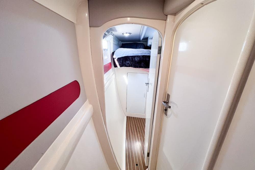 Interior of 2000 Leopard 38 yacht, featuring a cozy cabin with wood flooring.