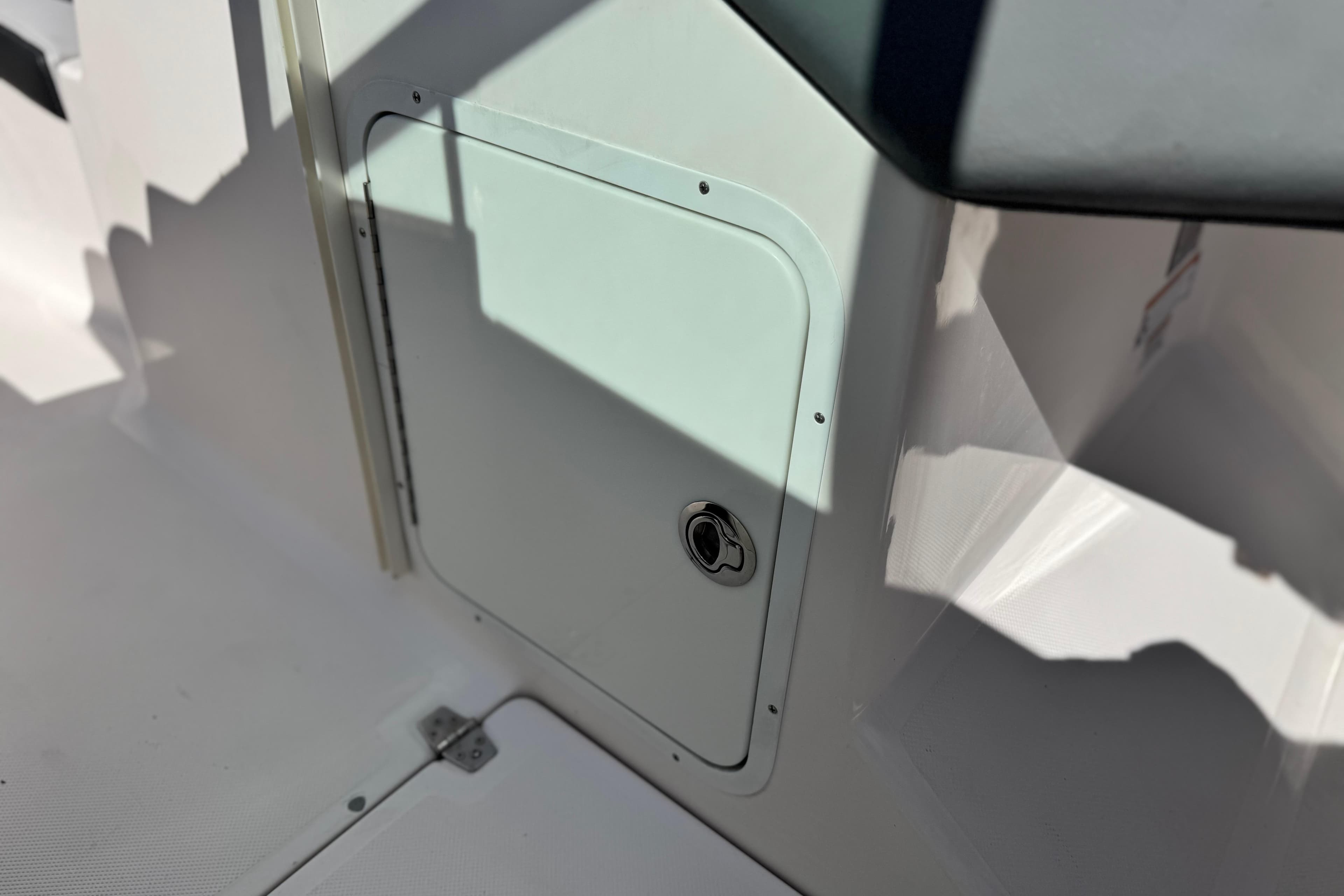 2014 Regal 27 FasDeck boat interior storage compartment with latch.