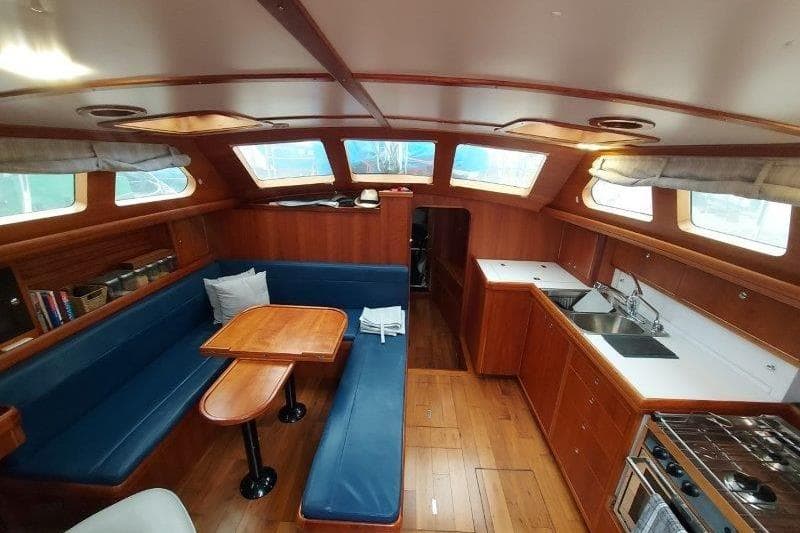 Interior of 2019 Custom Chatam Extreme 42 yacht with wooden finish and blue seating.