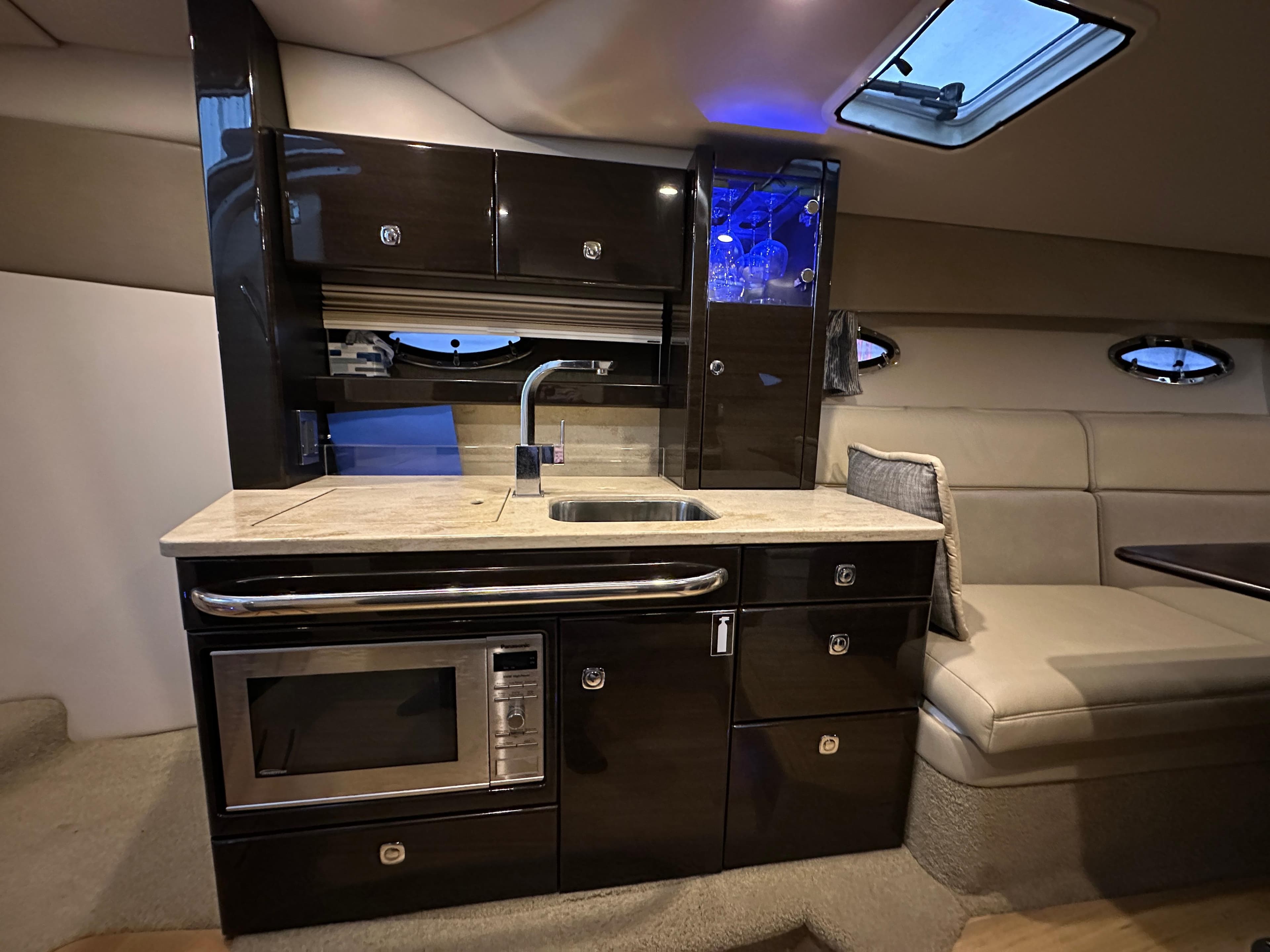 Luxurious interior of 2014 Formula 370 Super Sport yacht with modern kitchenette and seating area.