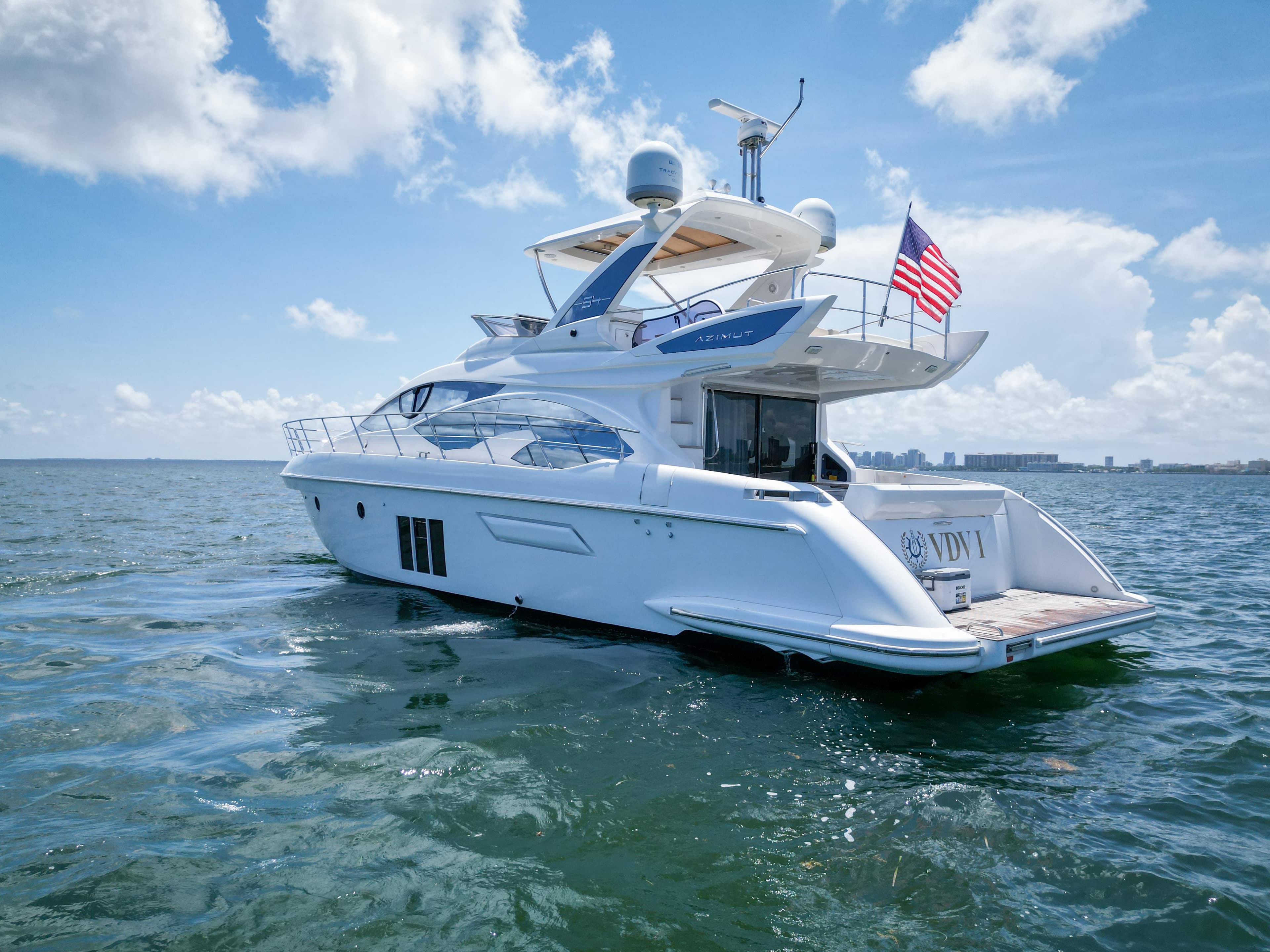 2015 Azimut 54 Fly yacht cruising on open water under a clear sky.