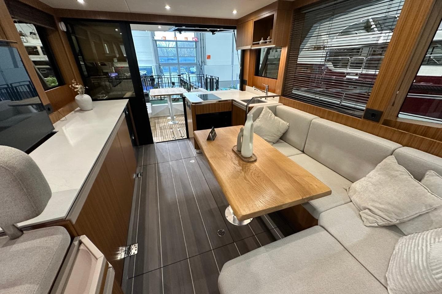 Luxurious interior of 2026 Greenline 42 yacht with modern seating and wooden accents.