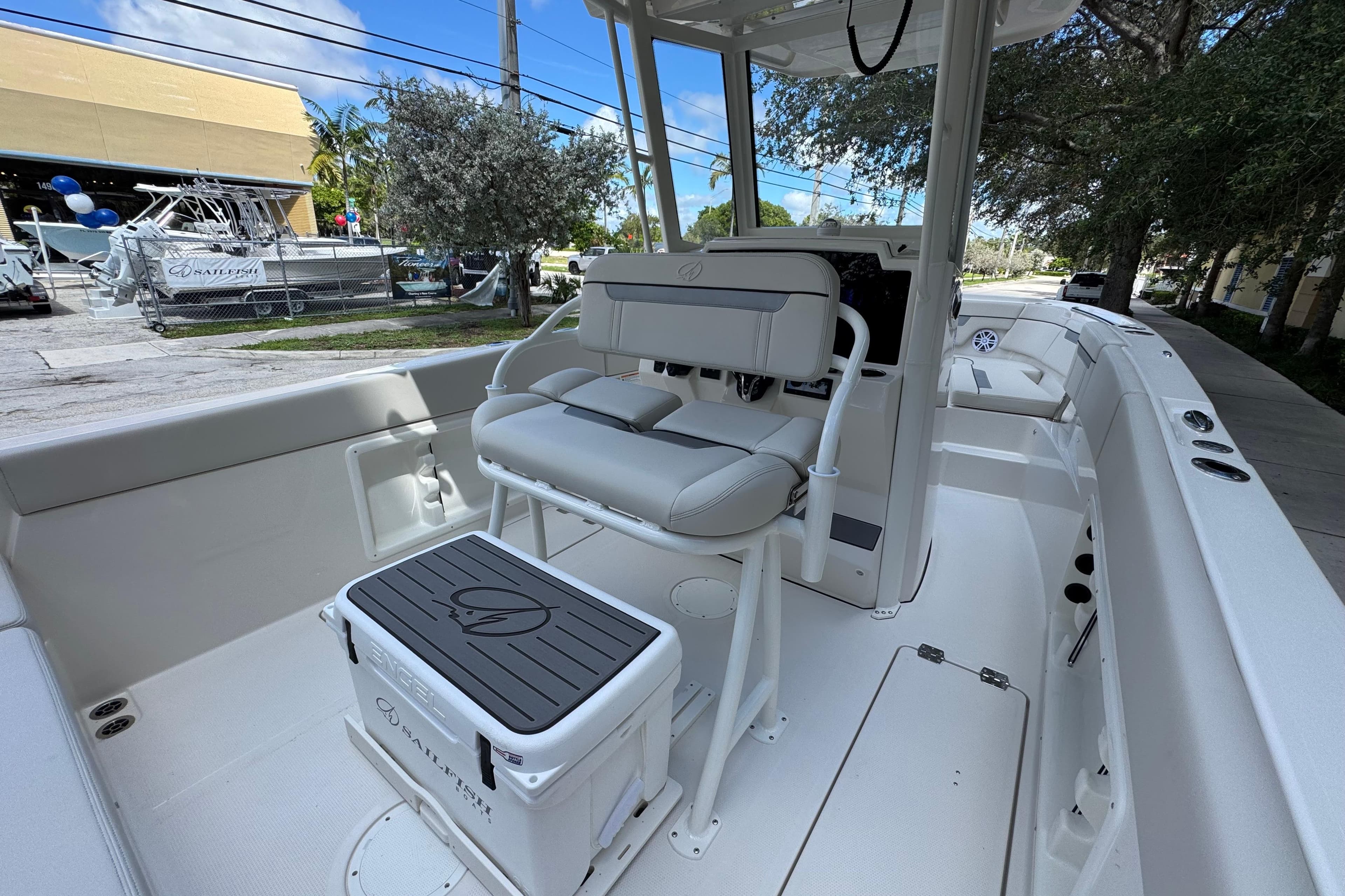 2026 Sailfish 252 boat interior with seating and console, parked outdoors.
