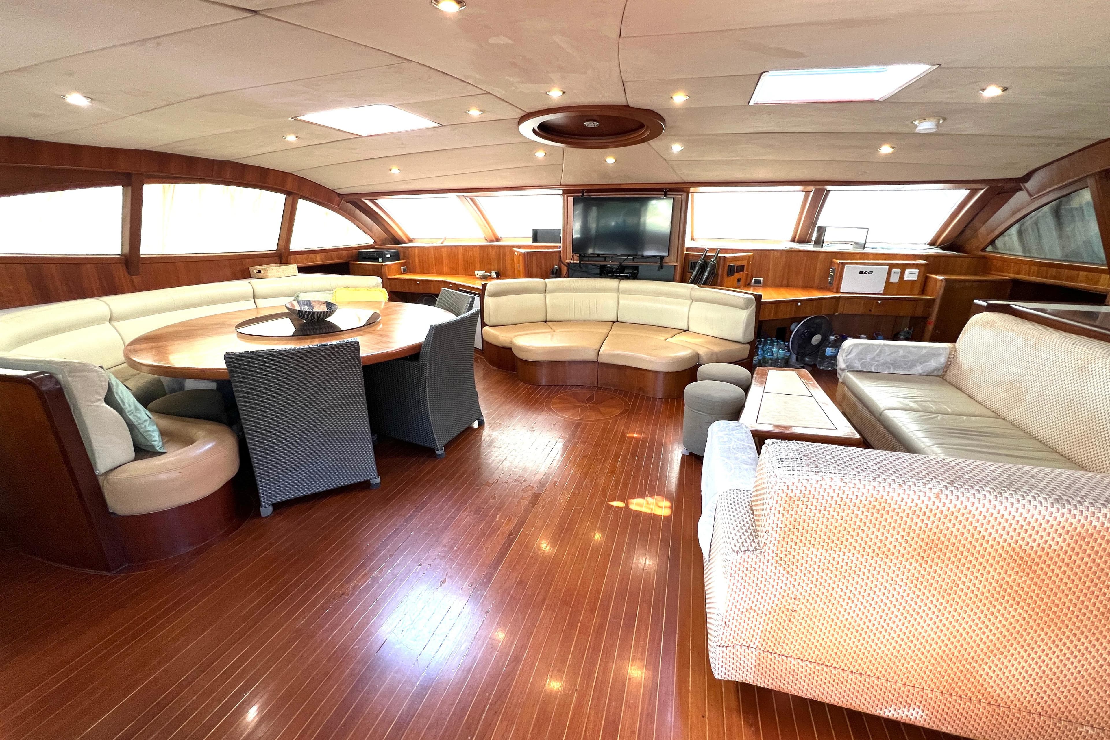 Luxurious interior of 2005 Concordia Dickson 69 yacht with elegant seating and wooden flooring.