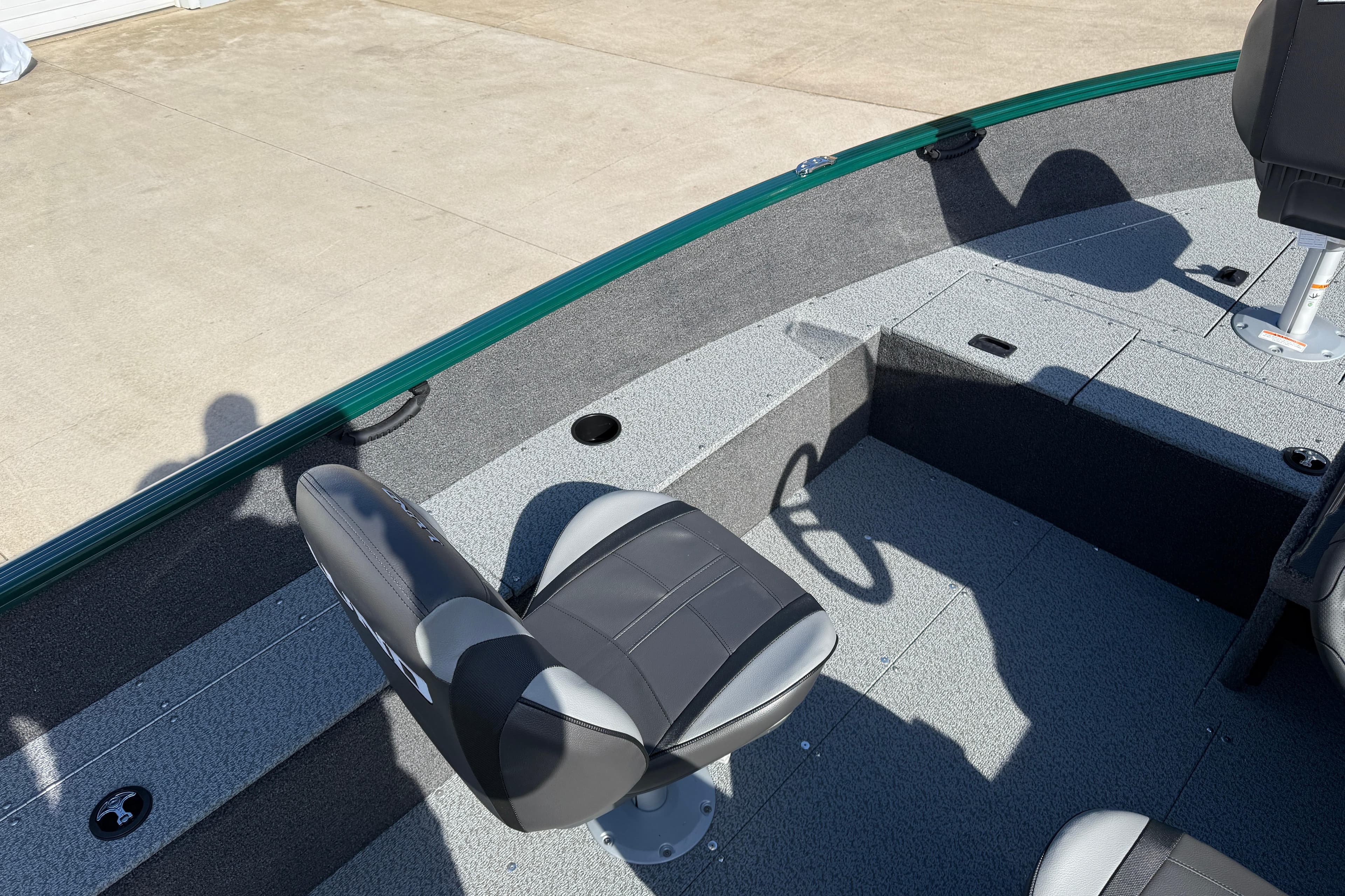 2026 Lund 1650 Rebel XL SS boat interior with seating and storage compartments.