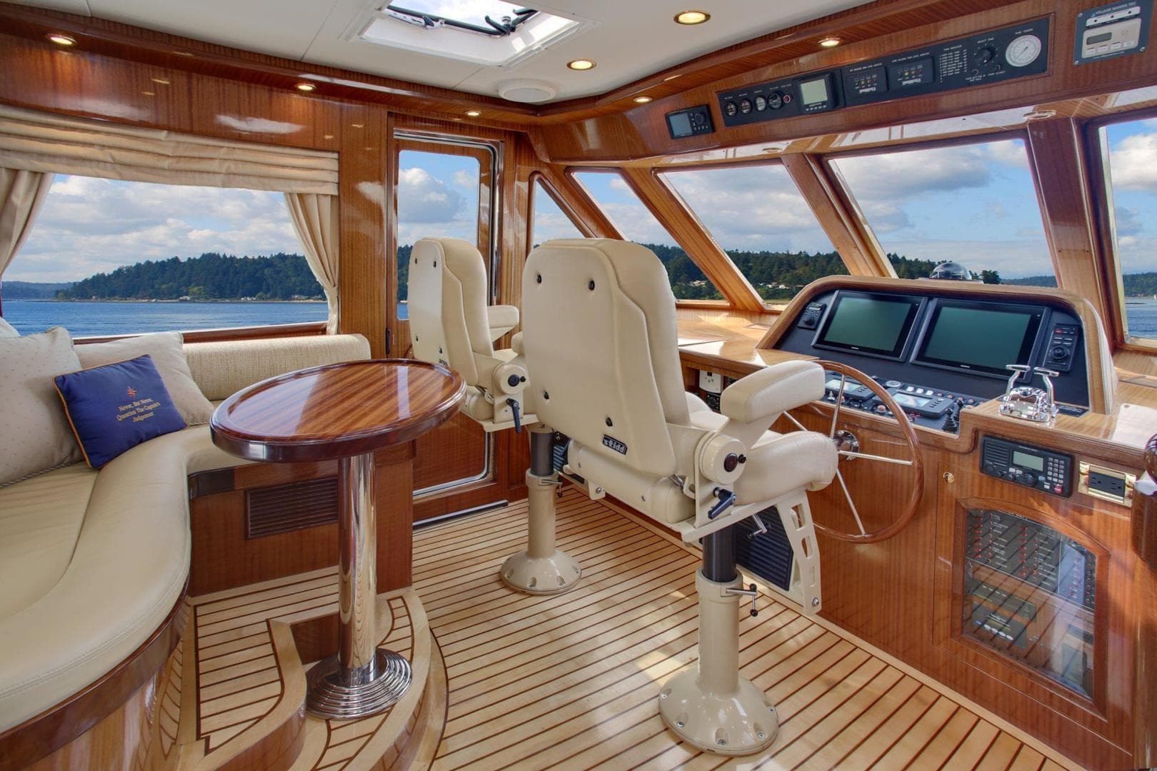Luxurious interior of 2027 Legend Boats 630 Skylounge with plush seating and advanced navigation.