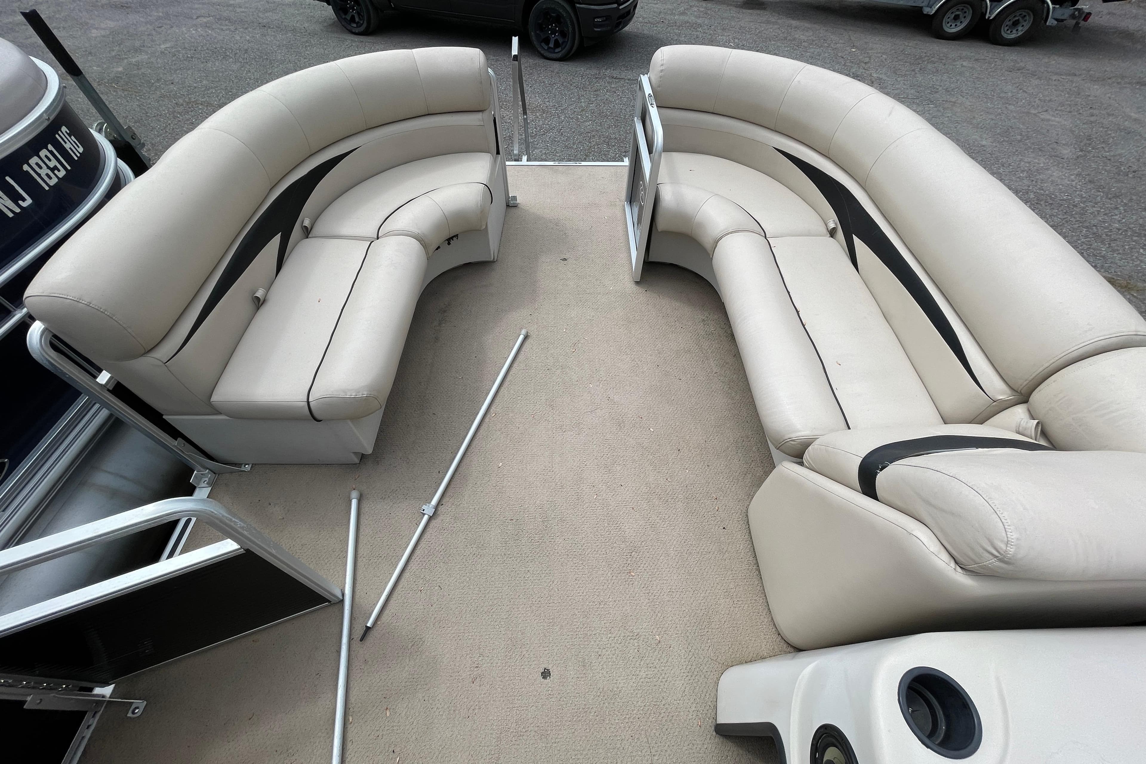 2010 Harris FloteBote 200 Cruiser CX interior with beige seating and open deck layout.