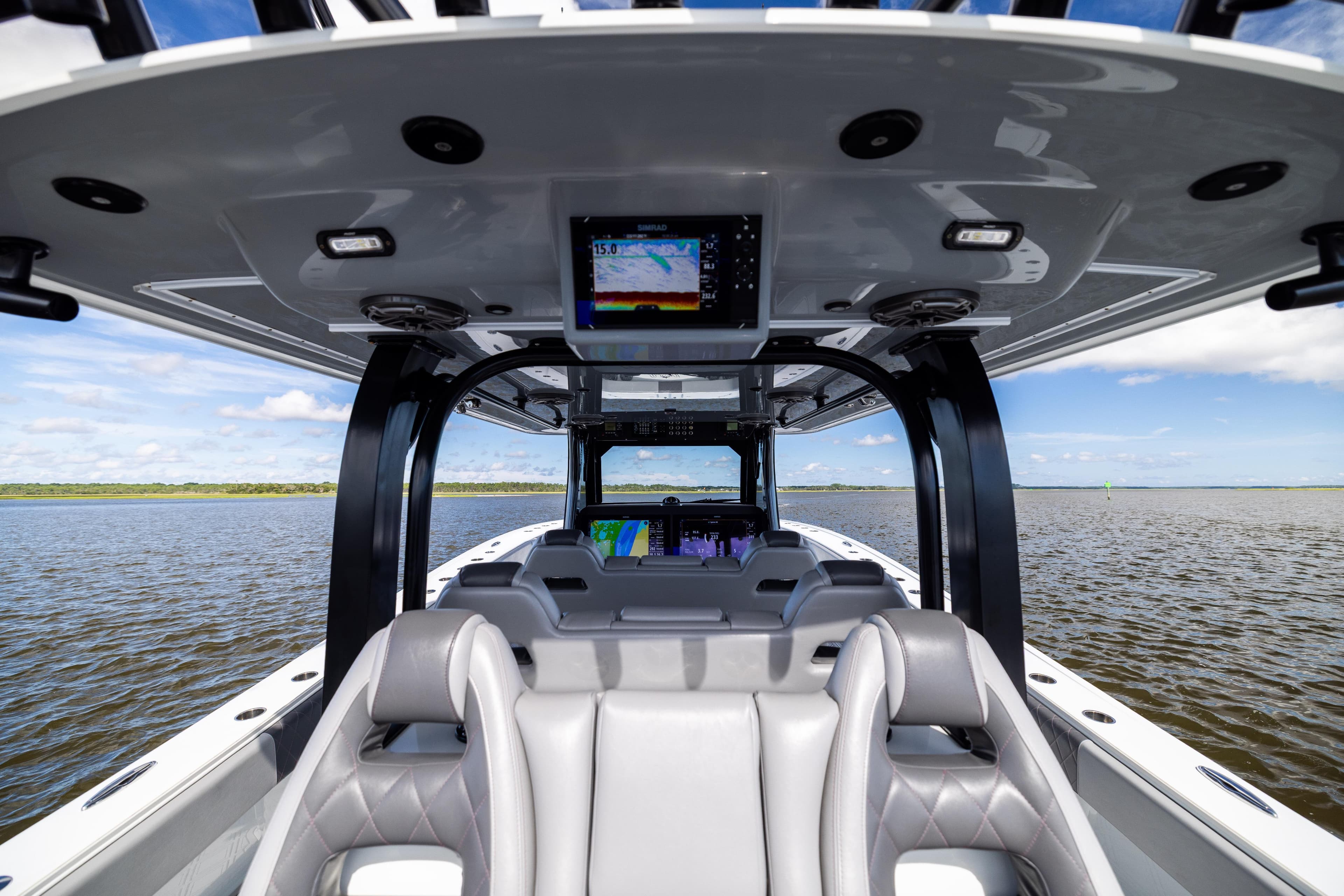 Interior view of 2023 Freeman 47 boat with modern seating and navigation system.
