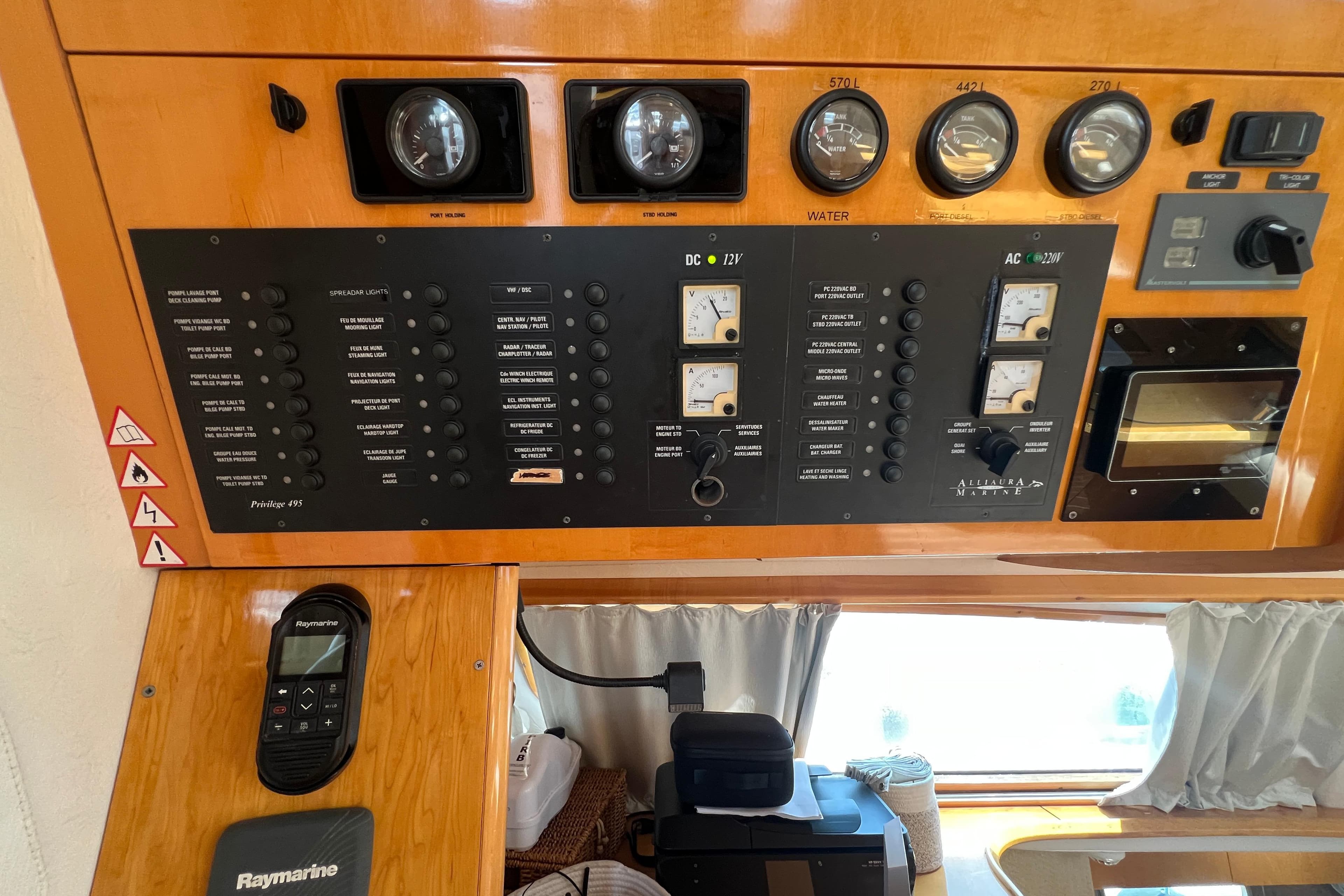 Control panel of a 2007 Privilege 495 yacht with gauges and switches.