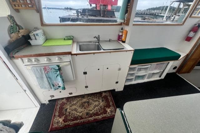 1972 REPCO Buxton Downeast Hardtop Cruiser interior with kitchenette and marina view.
