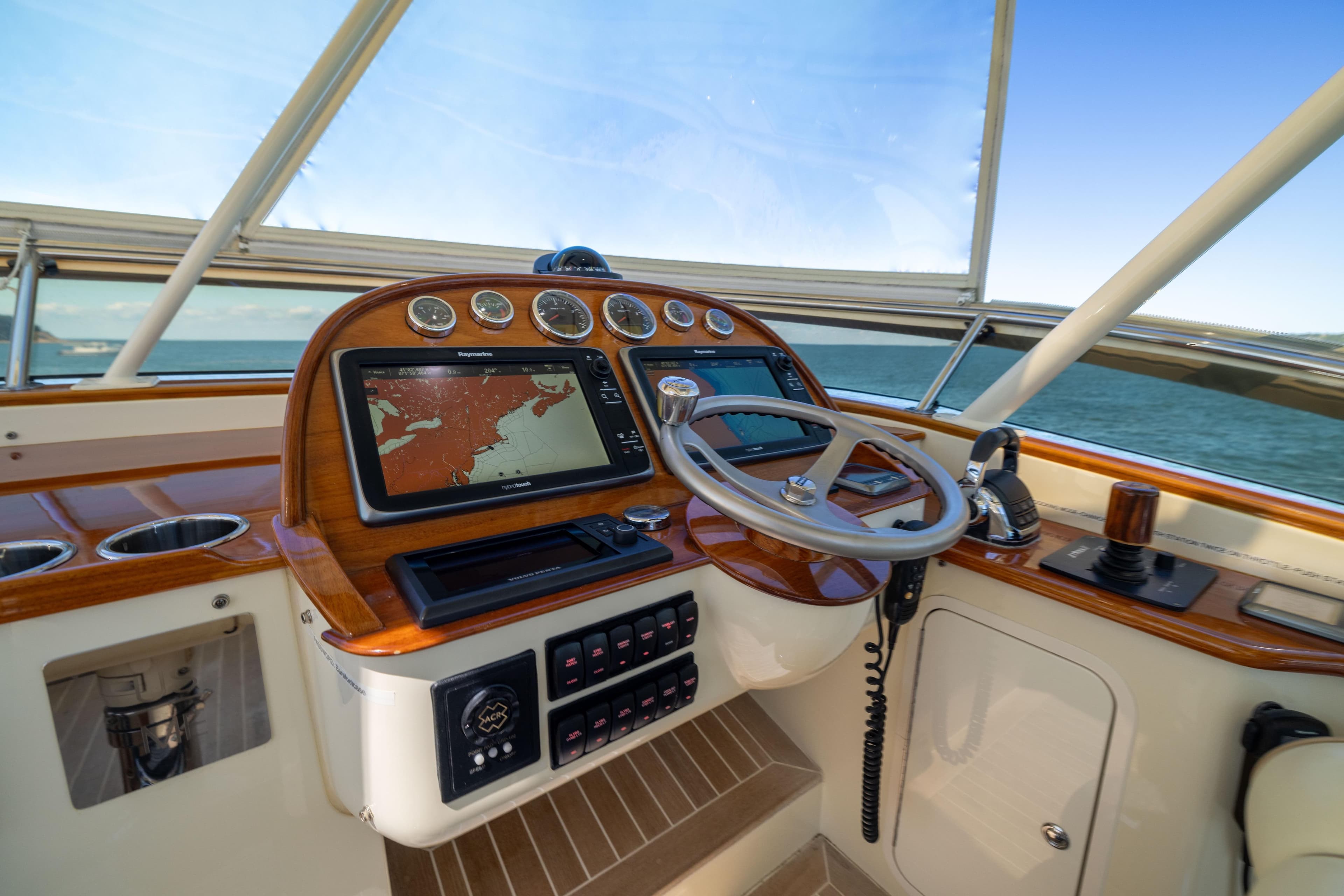 Helm of 2014 Hinckley Talaria 48 Flybridge with navigation system and controls.