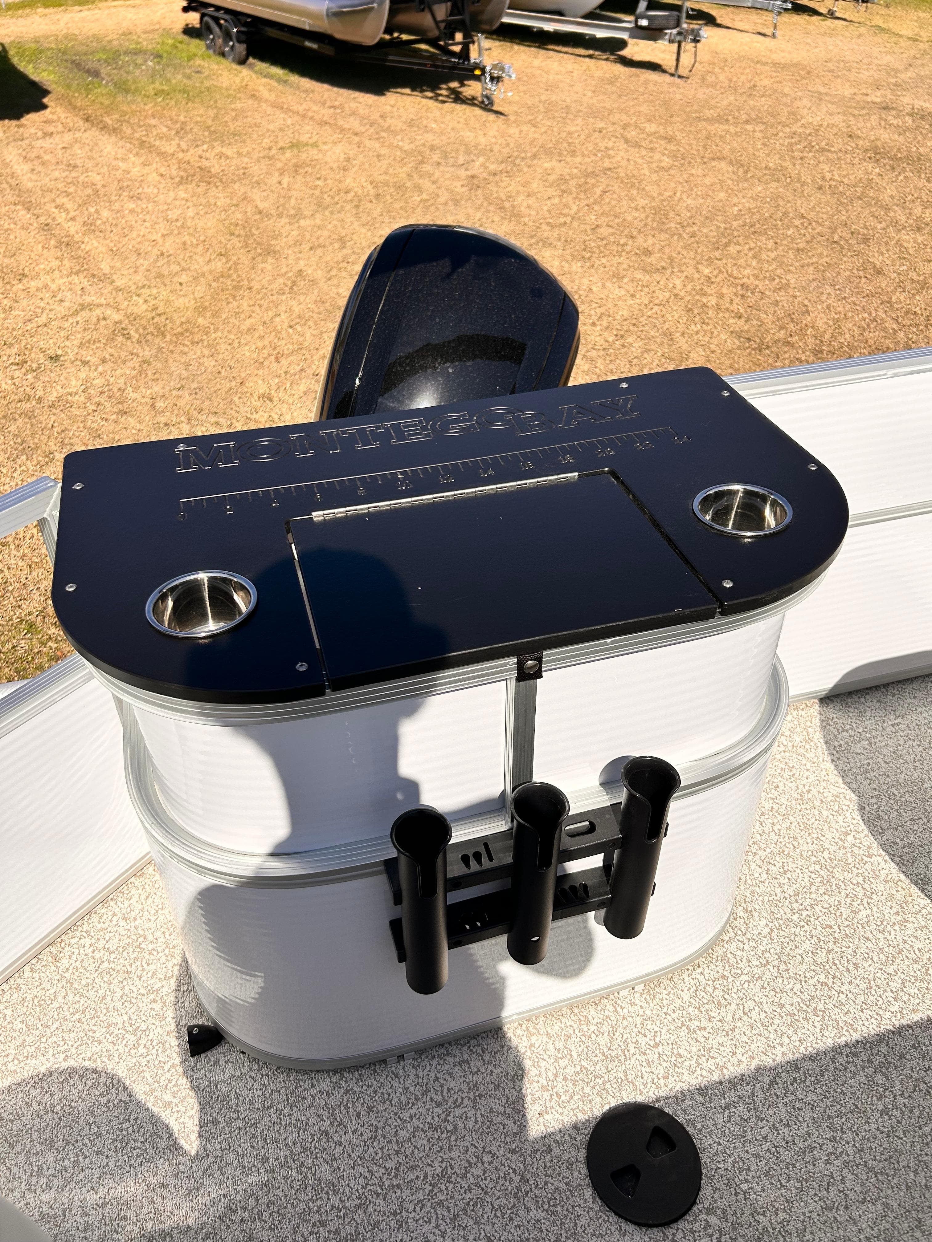 Montego Bay 8520 boat console, 2023 model, with cup holders and rod holders.