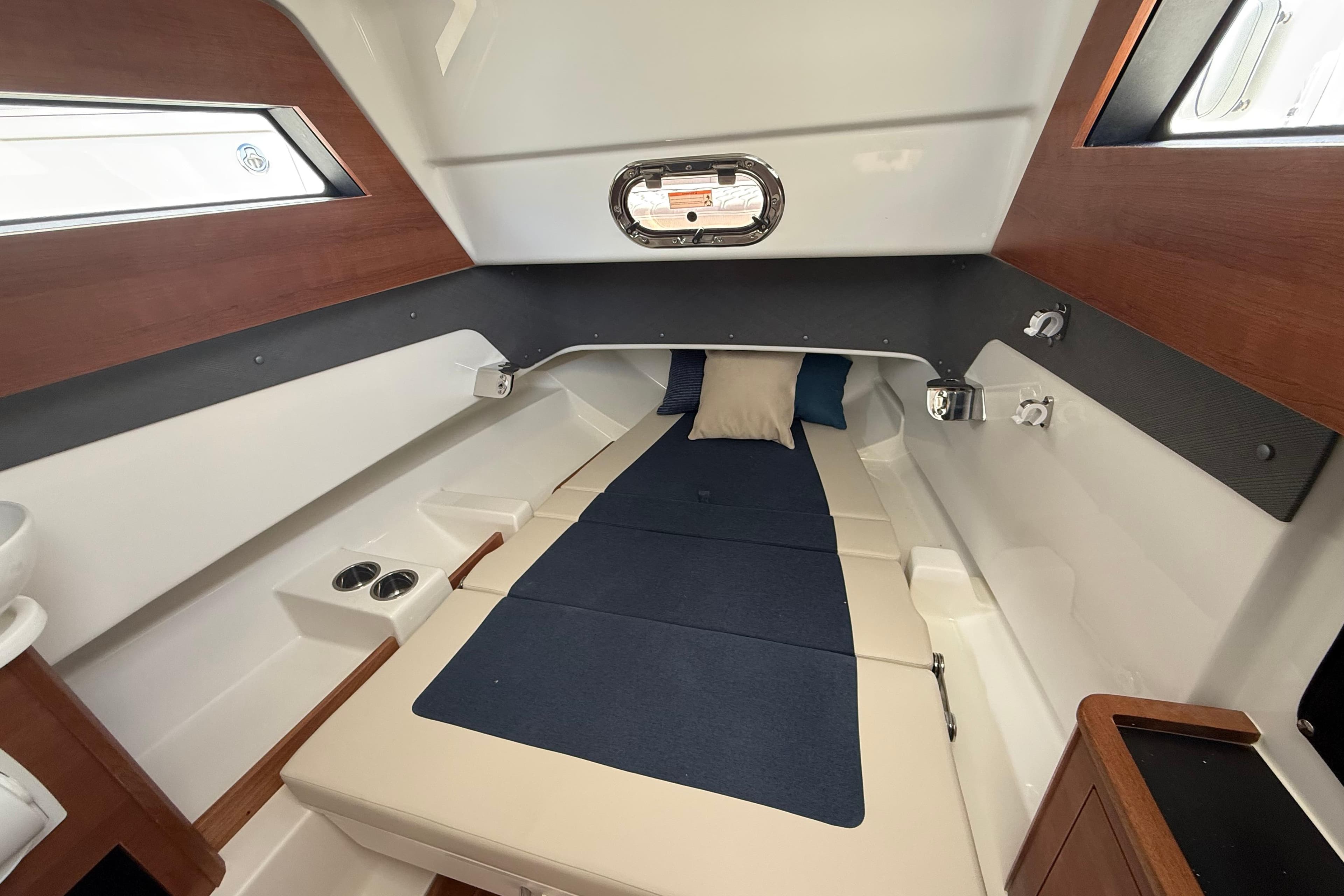 2026 Pursuit S 328 Sport cabin interior with cozy bed and modern design.