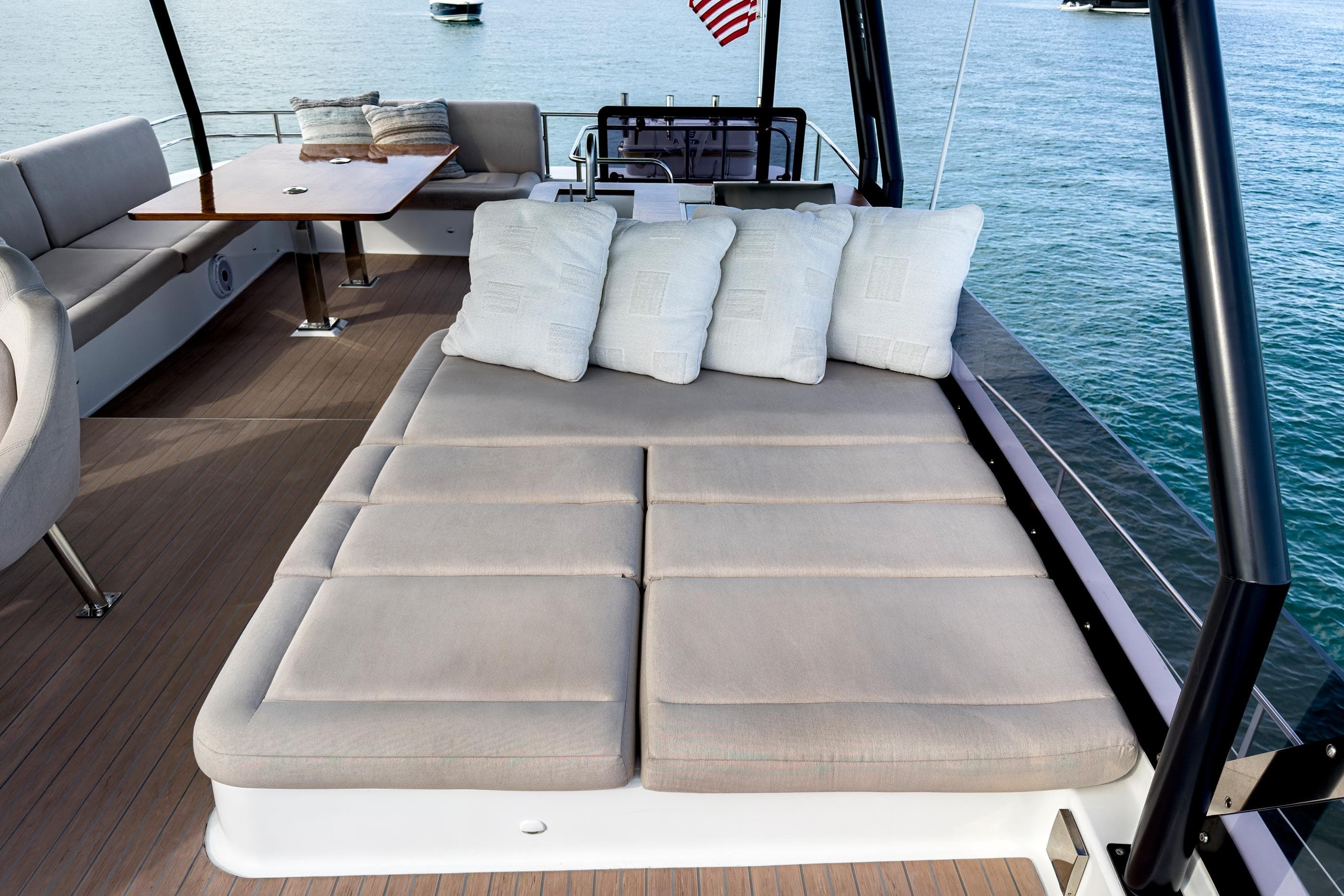 Luxurious 2022 Fountaine Pajot MY6 yacht deck with cushioned seating and ocean view.