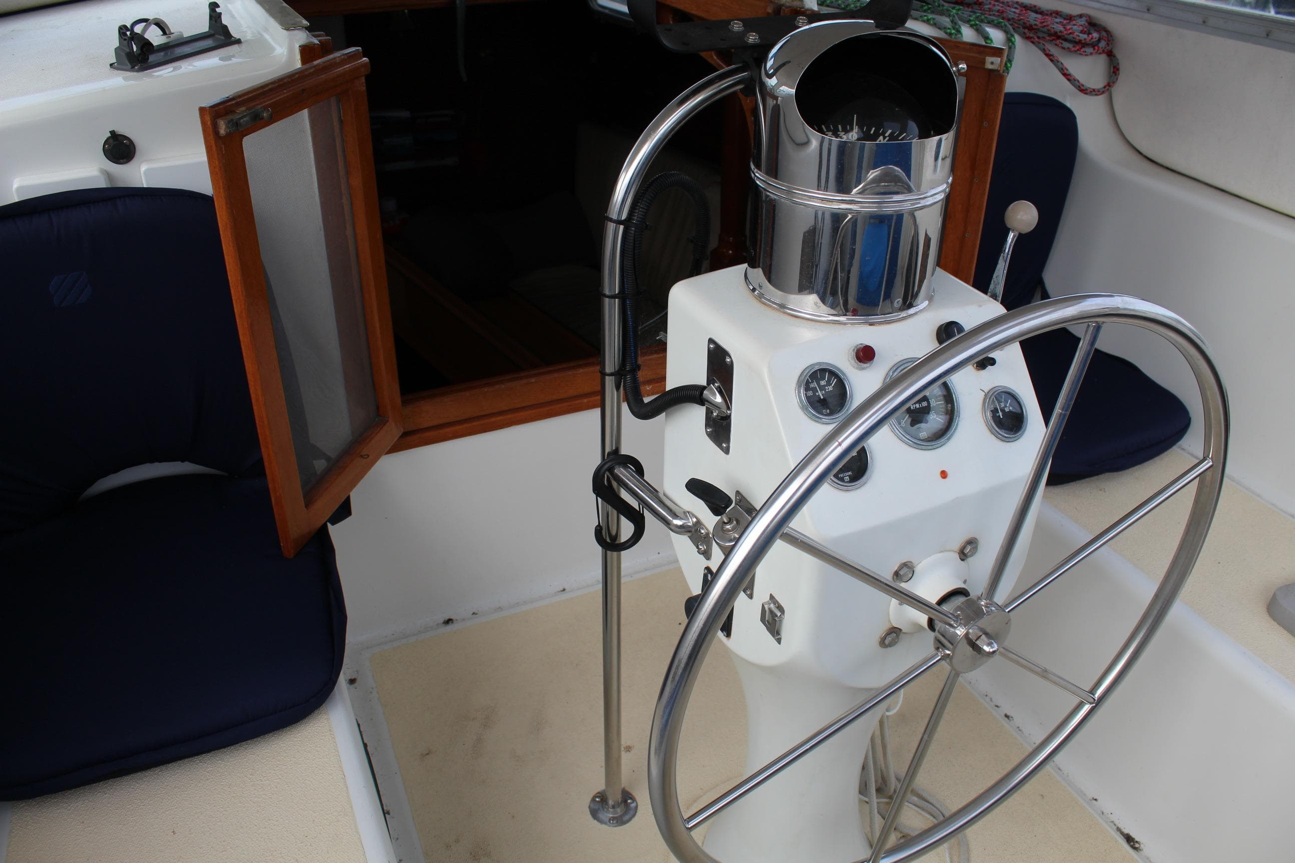 Helm of 1979 Spencer Yachts 53 with steering wheel and navigation instruments.