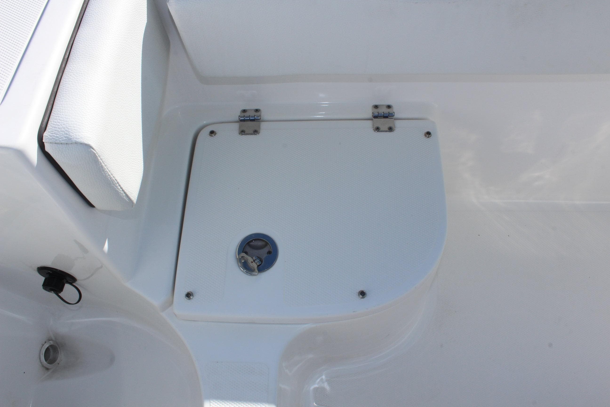 2024 Clearwater 2300 CC boat deck with storage compartment and seating.