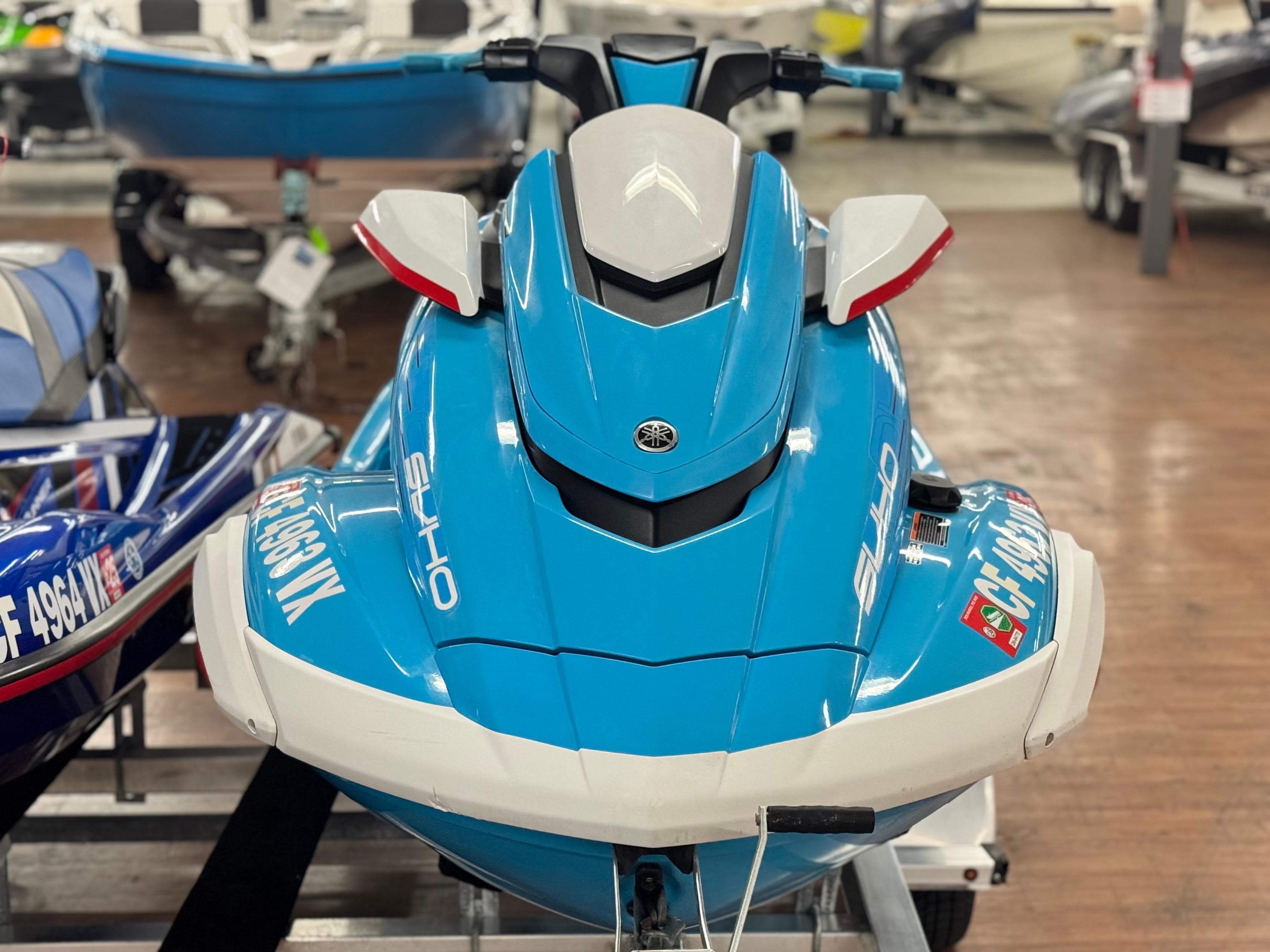 2022 Yamaha WaveRunner FX SVHO in showroom, vibrant blue color, front view.