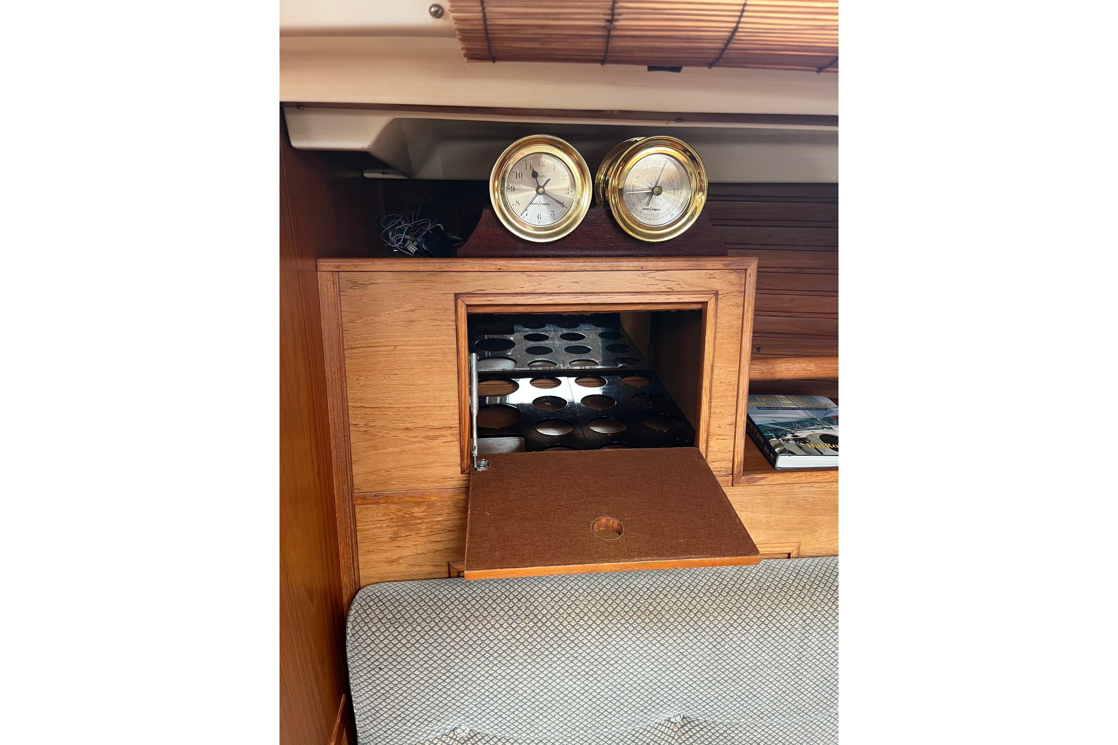 Interior of 1986 Wauquiez Petorine yacht with wooden cabinetry and nautical instruments.