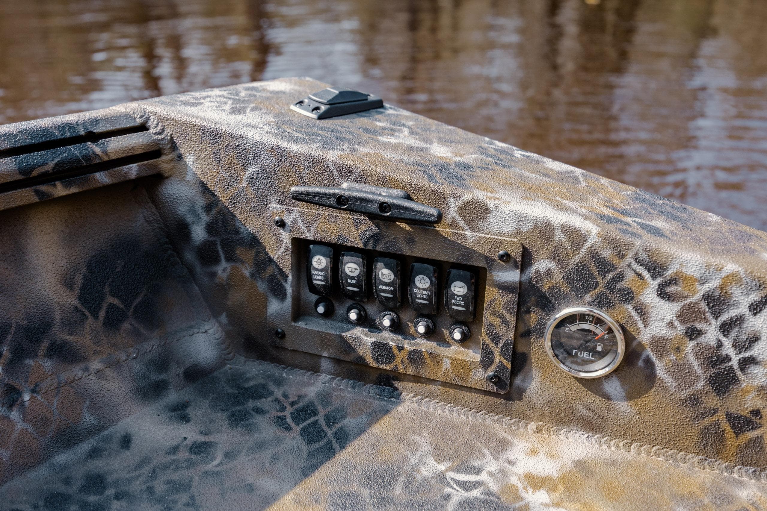 Control panel of 2026 Excel 183 Tomahawk boat with camouflage design and fuel gauge.