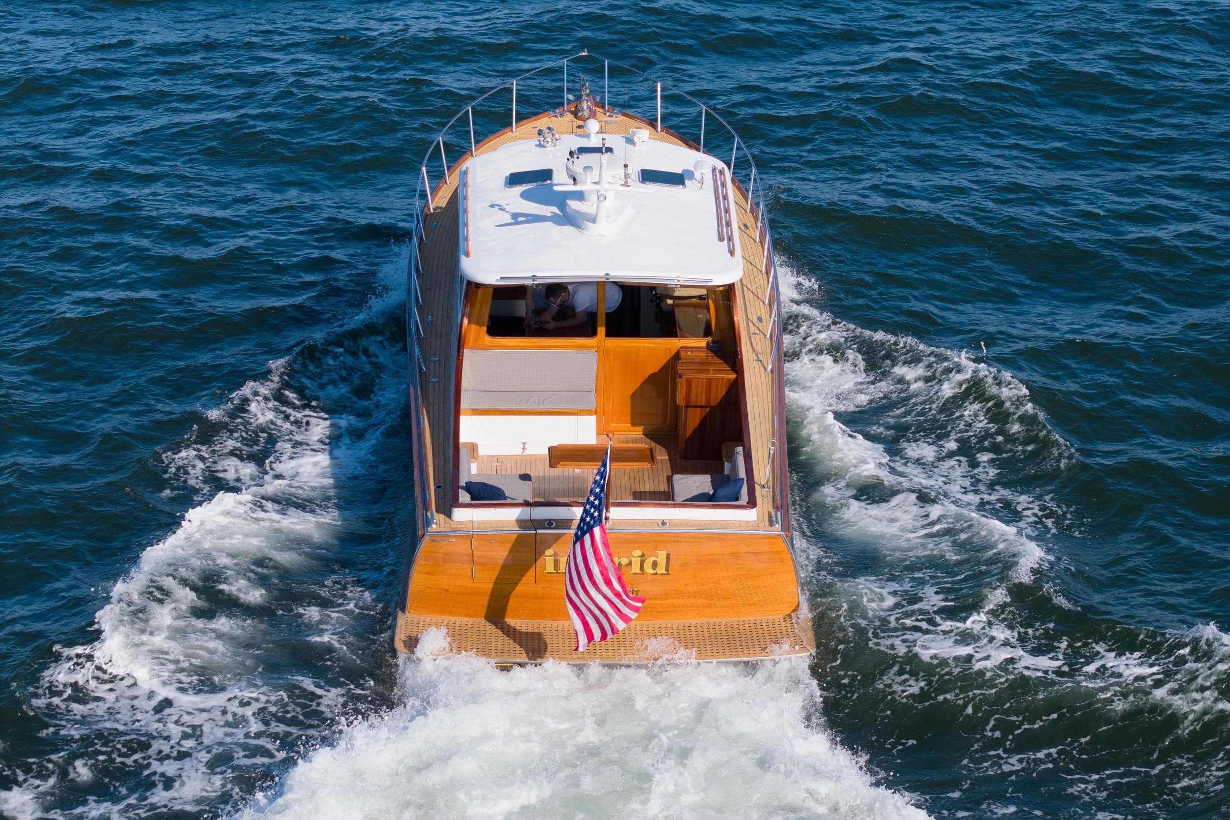 Gorbon Custom Downeast 40 yacht cruising on open water, American flag displayed.