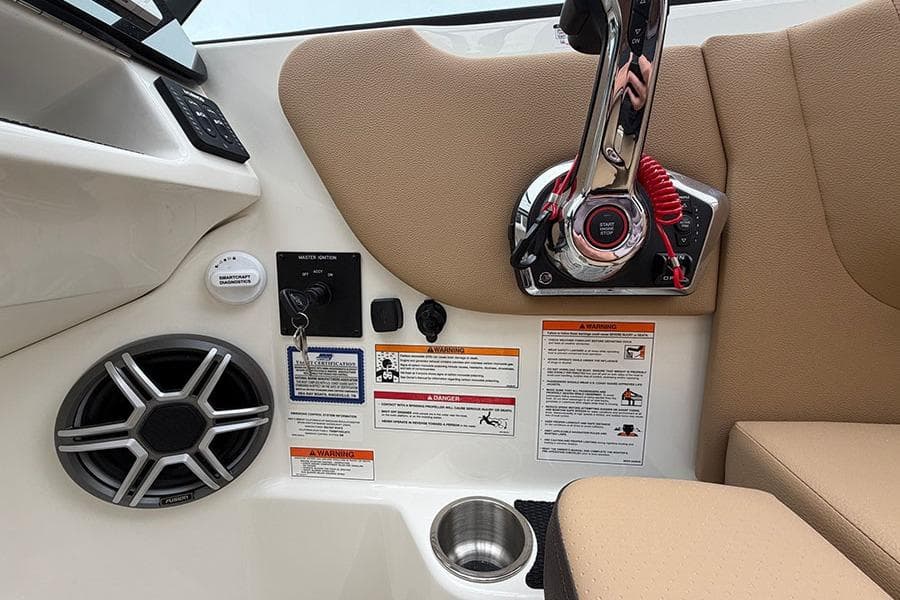 2026 Sea Ray SDX 270 Outboard boat controls with speaker and warning labels.