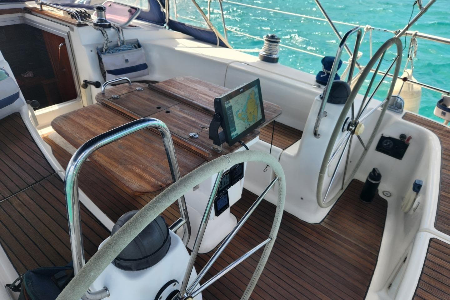 Cockpit of 2004 Bavaria 44 sailboat with dual steering wheels and navigation equipment.